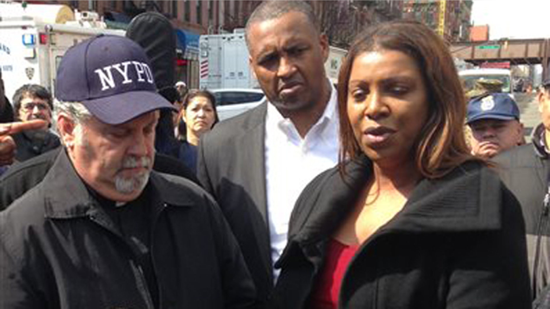 Rick Del Rio, pastor of Abounding Grace church in Manhattan, and New York City Public Advocate Letitia James, display a damaged but intact Bible they said was recovered in the rubble of the Spanish Christian Church, Saturday, March 15, 2014 in New York. The church was in one of the buildings destroyed in the March 12 gas explosion that leveled two building and killed eight people. (AP Photo/Jim Fitzgerald)