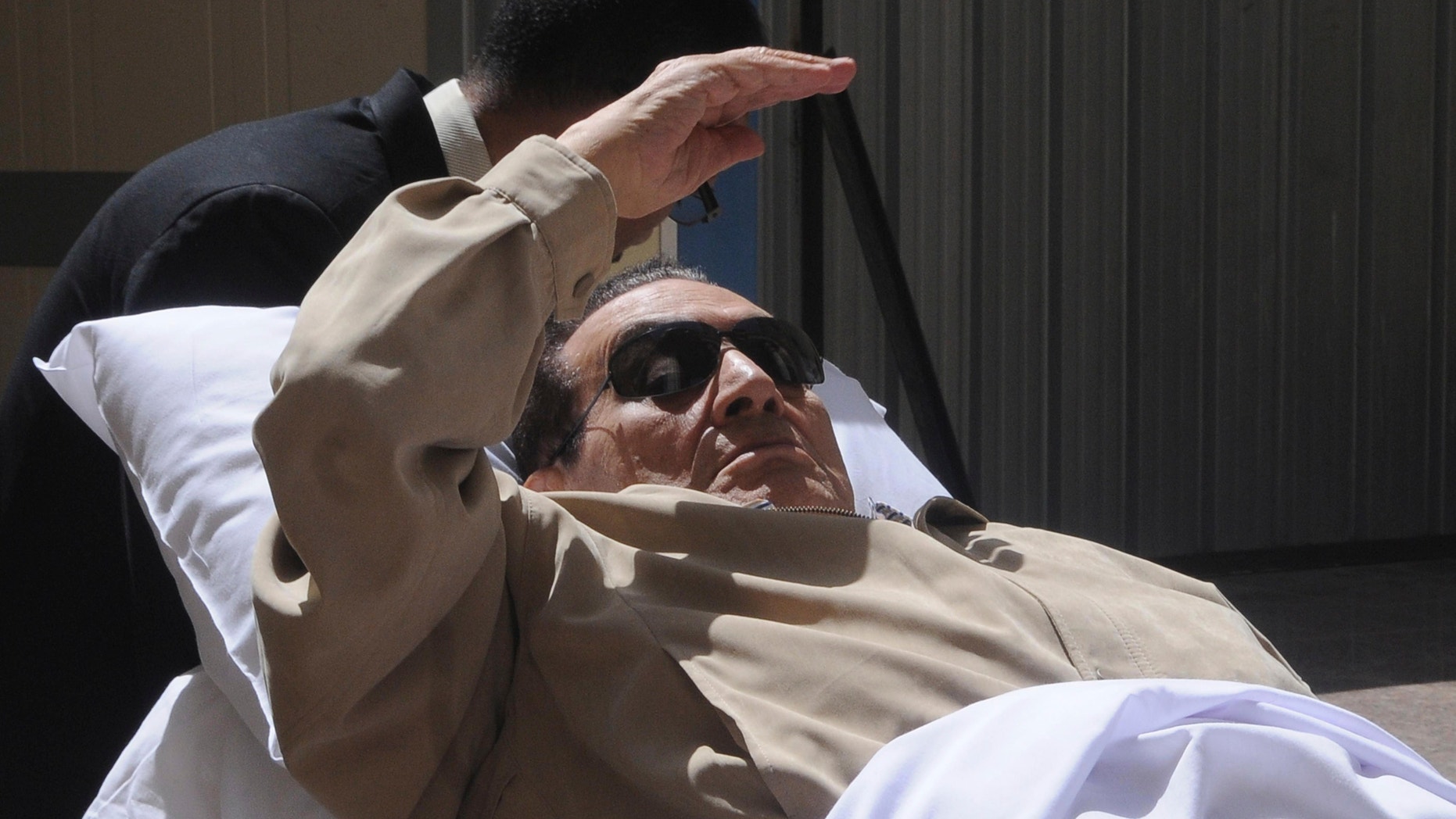 June 2, 2012: Egypt's ex-President Hosni Mubarak lays on a gurney as he arrives at the police academy courthouse in Cairo, Egypt.