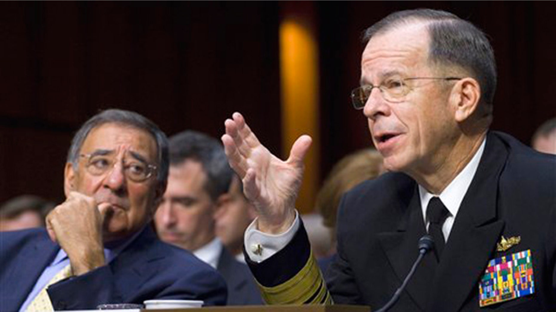 Defense Secretary Leon Panetta looks on at left as Joint Chiefs Chairman Adm. Michael Mullen, testifies on Capitol Hill in Washington, Thursday, Sept. 22, 2011, before the Senate Armed Services Committee hearing on U.S. strategy in Afghanistan and Iraq.