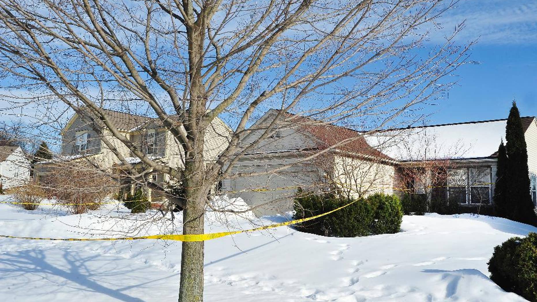 In this photo taken on March 7, 2014, police tape is scene outside a home in Pontiac, Mich., where the mummified body of a woman was found in the garage. Paula Logan has said the body found last week in Pontiac is that of Pia Farrenkopf, her sister. Authorities investigating the discovery haven't released her name, but they have said that the woman apparently died in 2008 at the age of 49. The Detroit Free Press reports voting records show Farrenkopf as voting in the November 2010 gubernatorial election. Officials say, however, that it may represent an administrative error. (AP Photo/Detroit News, Daniel Mears) DETROIT FREE PRESS OUT; HUFFINGTON POST OUT; MAGS OUT MANDATORY CREDIT.