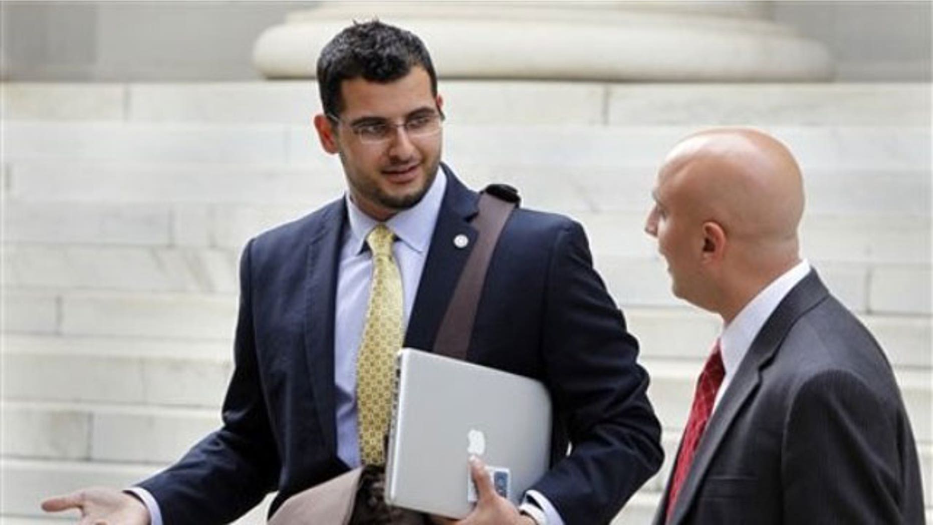 September 12, 2011: Muneer Awad, left, executive director of the Council on American-Islamic Relations in Oklahoma talks with attorney Gadeir Abbas as they leave federal court in Denver.