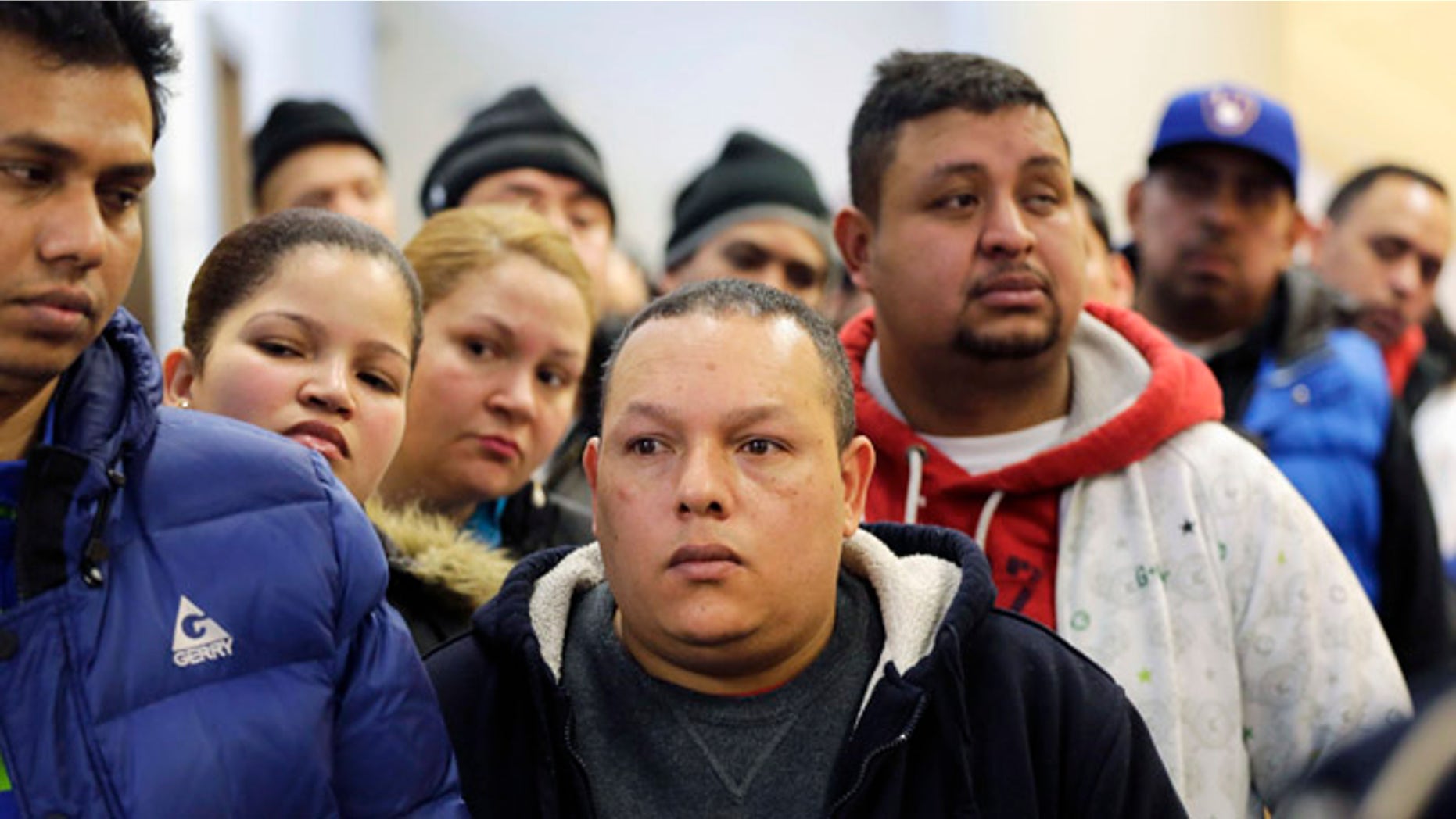 People wait in line to apply for municipal identification cards in the Bronx borough of New York on Jan. 12, 2015.