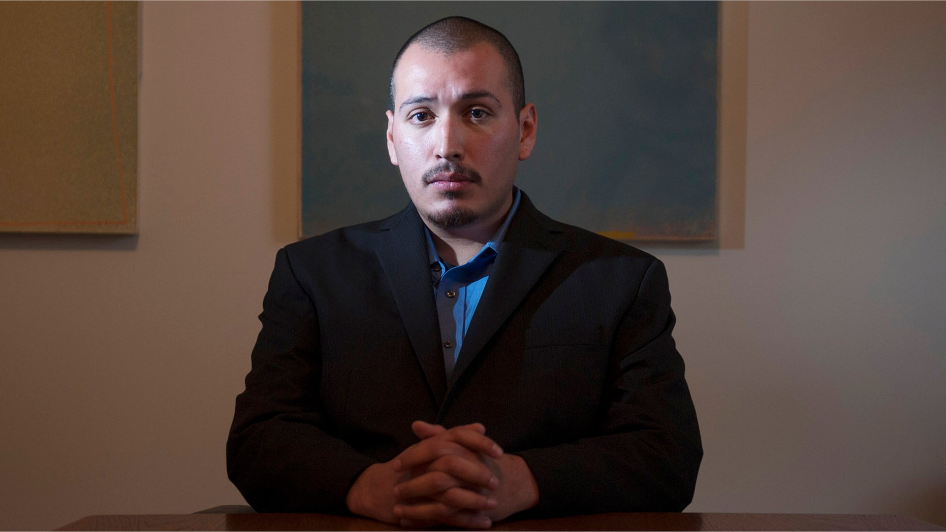 In this Dec. 7, 2013 photo, Eder Herrera poses for a photo. The Southern California city of Brea will pay $700,000 to Herrera who was arrested in the 2011 killings of his mother and brother but was freed when his high school friend confessed to the crimes, lawyers said Tuesday, April 28, 2015. (Miguel Vasconcellos/The Orange County Register via AP)