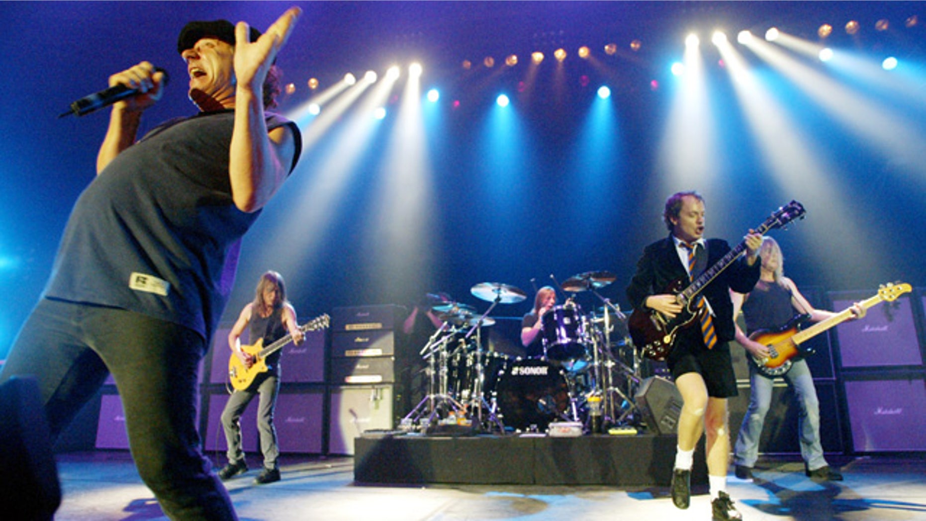 FILE - This June 17, 2003 file photo shows British rock band AC/DC, from left, Brian Johnson, Malcolm Young, Phil Rudd, Angus Young, and Cliff Williams performing on stage during a concert in Munich, southern Germany. Malcolm Young of AC/DC is taking a break from the band to focus on his health. (AP Photo/Jan Pitman, File)