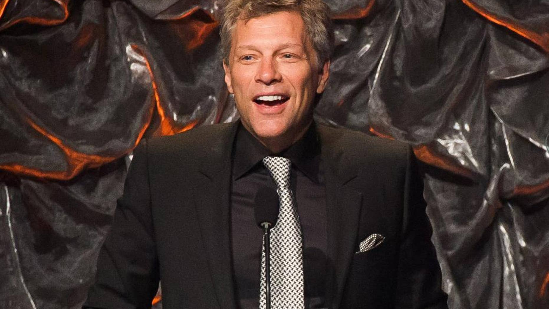 FILE - In this June 12, 2014 file photo, Jon Bon Jovi attends the Songwriters Hall of Fame Awards in New York. Promoters of Bon Jovi’s upcoming shows in Asia said they are being canceled for “unforeseen reasons.” AEG Live Asia said in a statement Tuesday, Sept. 8, 2015 that refunds will be offered for shows scheduled for Sept. 14 in Shanghai and Sept. 17 in Beijing.(Photo by Charles Sykes/Invision/AP, File)