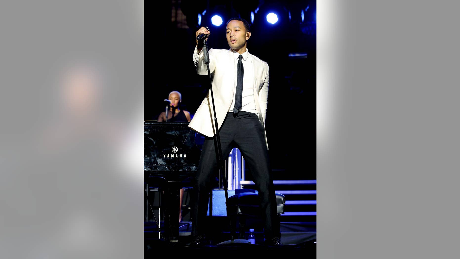 FILE - This Jan. 31, 2014 image released by Starpix shows John Legend performing at the Shape Magazine and Men's Fitness Super Bowl Party at Cipriani 42nd Street in New York. There will be wiggling and shaking and all kinds of pelvic gyrations going on when Jason Derulo helps Luke Bryan and Florida Georgia Line kick off the CMT Music Awards. Derulo and John Legend, who will sing with Jennifer Nettles and Hunter Hayes, are among the surprise guests scheduled to perform Wednesday, June 4, 2014, on the always kooky awards show. (AP Photo/Starpix, Marion Curtis, File)