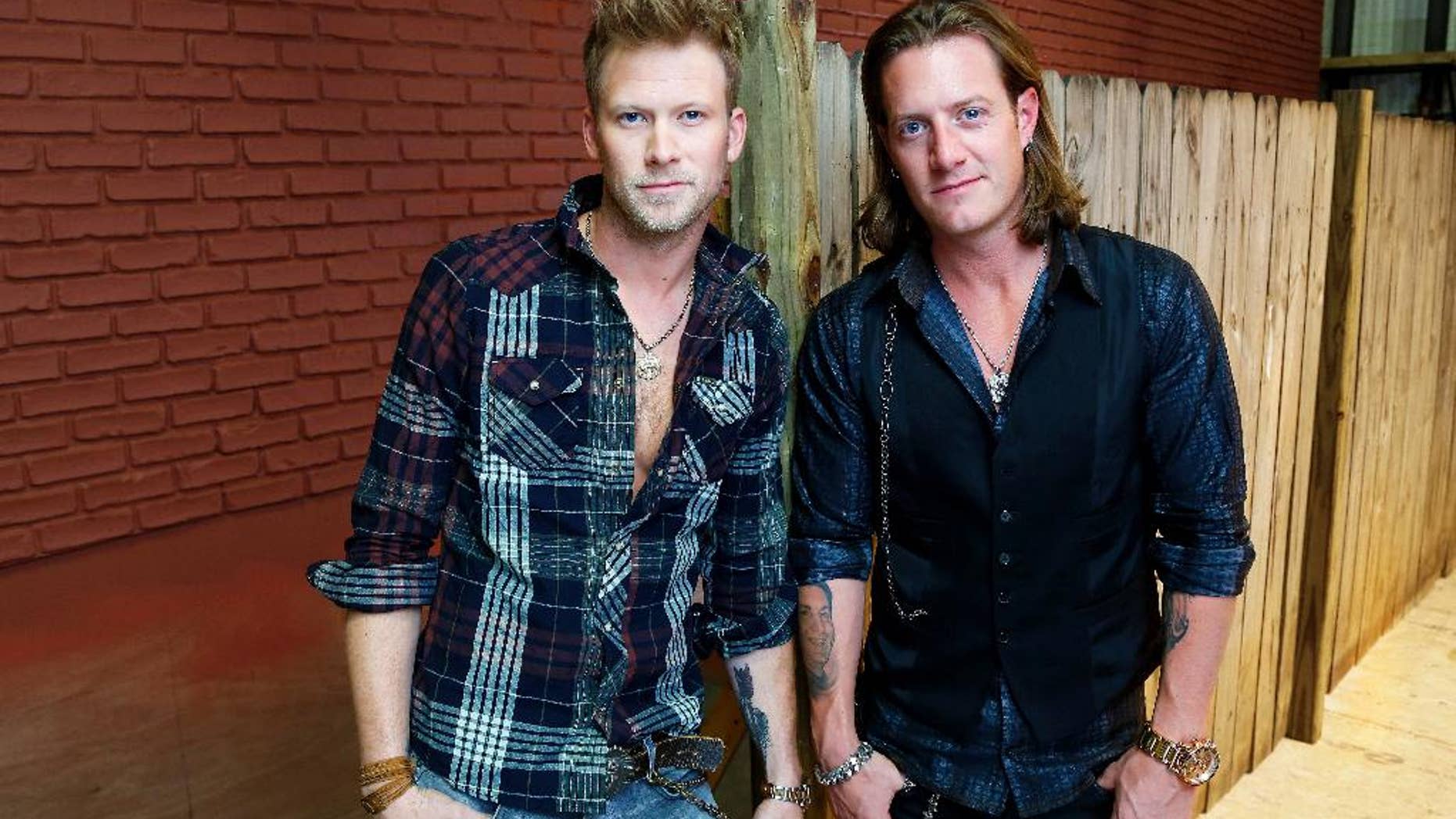 In this Sept. 24, 2014 photo, members of Florida Georgia Line, Brian Kelley, left, and Tyler Hubbard pose for a photo in Nashville, Tenn., to promote their latest album, "Anything Goes." (Photo by Donn Jones/Invision/AP)