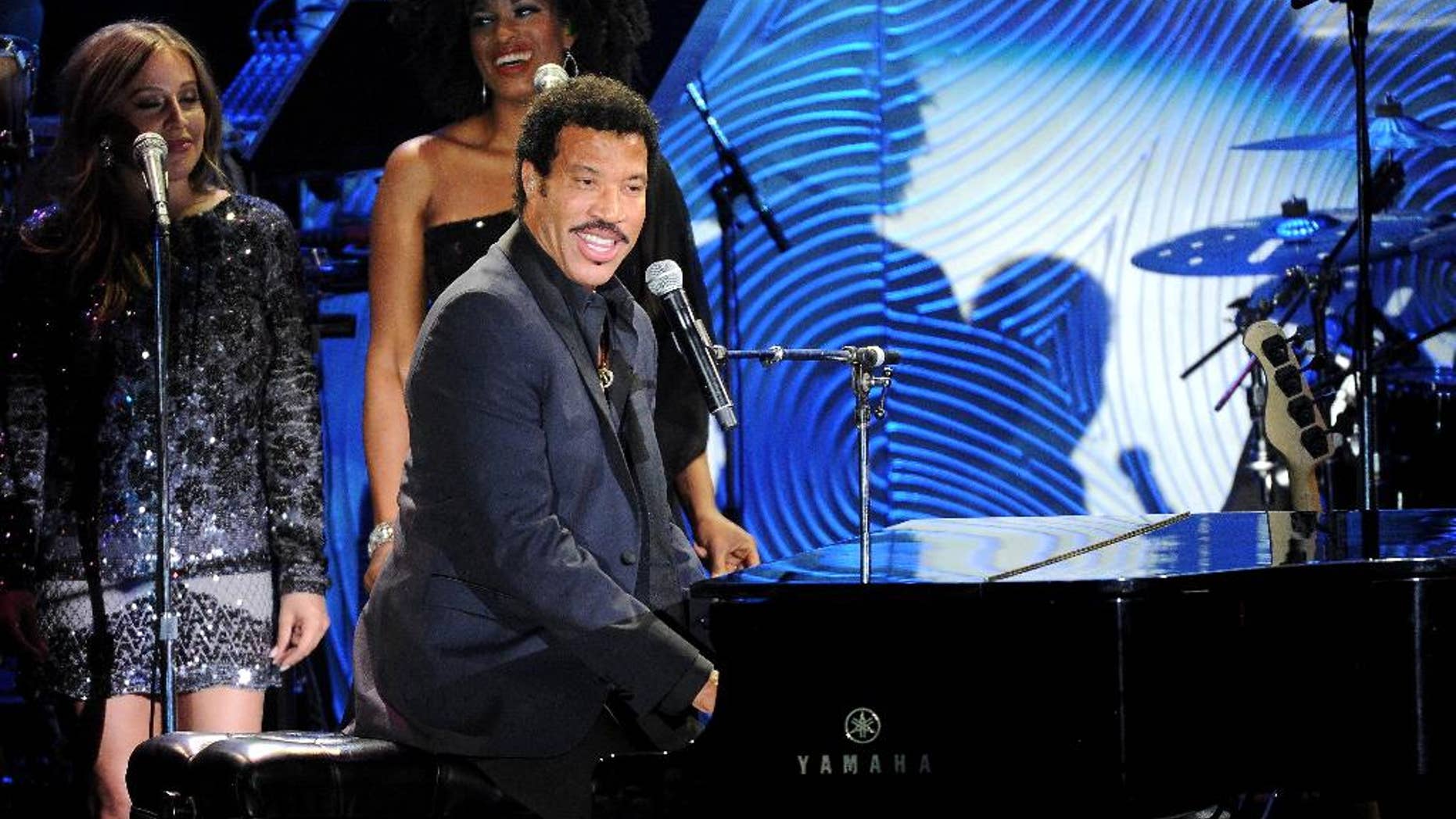 FILE - In this Jan. 25, 2014 file photo, recording artist Lionel Richie performs onstage at The 56th Annual GRAMMY Awards Salute to Industry Icons with Clive Davis, at the Beverly Hilton Hotel in Beverly Hills, Richie is keeping busy with his “All the Hits All Night Long” tour, which kicks off its second North American leg May 29, 2014, in Vancouver. (Photo by Frank Micelotta/Invision/AP, file)