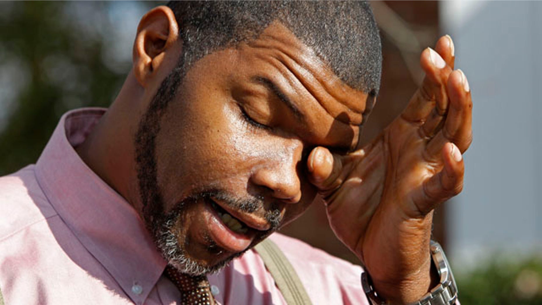 Nov. 23: Anthony Tisdale, right, father of Delvonte Tisdale, wipes his face during a news conference in front of his home in Charlotte, N.C.