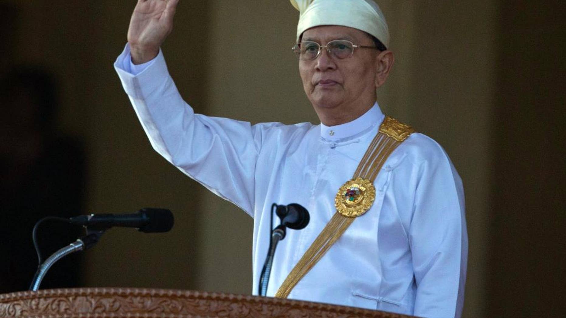 FILE - In this Jan. 4, 2015 file photo, Myanmar President Thein Sein waves during a ceremony to mark Myanmar's 67th anniversary of Independence Day in Naypyitaw, Myanmar. The president's office says he has not yet decided whether to pursue a second term in office but will base his decision on how the ruling party fares in parliamentary elections this November. His office denied a news report Tuesday, July 14, 2015 that quoted an anonymous official as saying Thein Sein would not run in parliamentary elections due to health concerns. (AP Photo/Gemunu Amarasinghe, File)