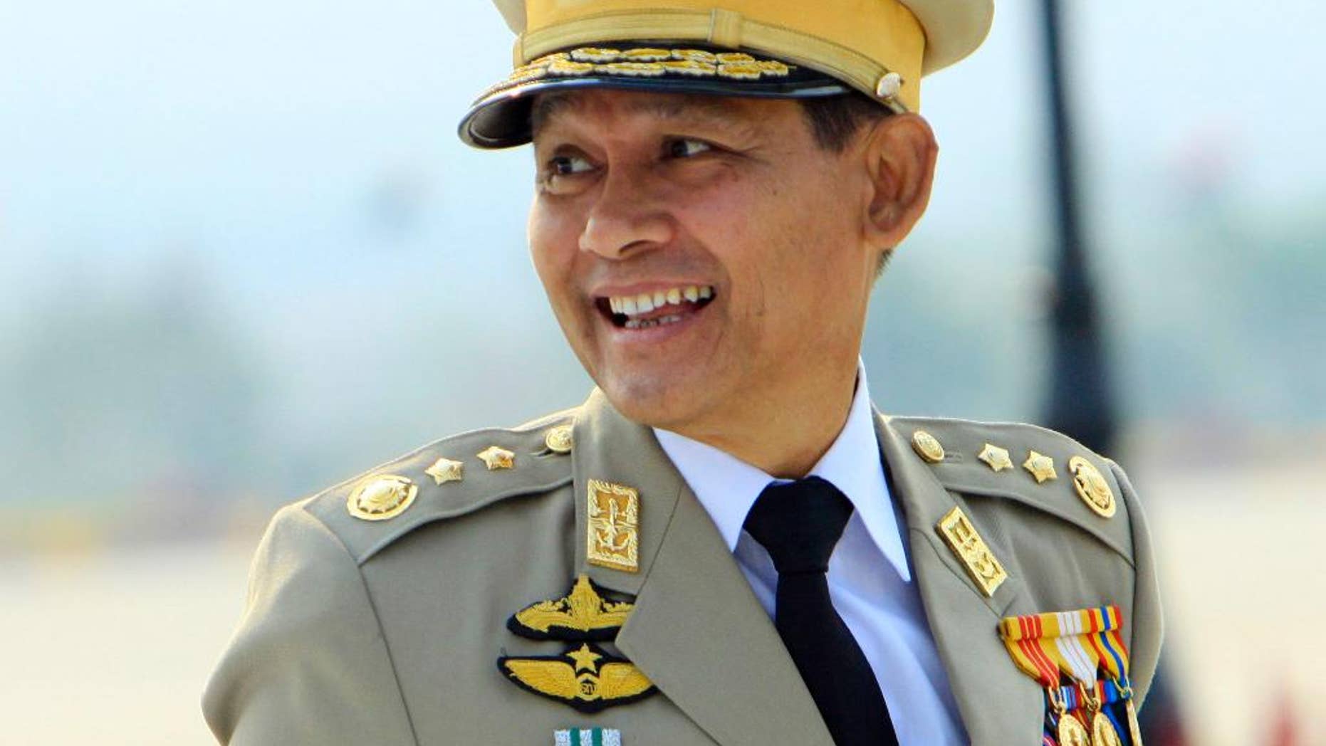 In this photo taken on March 27, 2010, Myanmar ex-religious minister Hsan Sint smiles as he attends the 65th anniversary Armed Forces Day in Naypyitaw, Myanmar. A court sentenced Myanmar's ex-religious affairs minister to 13 years in jail Friday for embezzling state funds and sedition - the harshest penalty given to a high-ranking official since the country began its transition toward democracy. Hsan Sint was removed from office in June following allegations he misused $10,000 to build a pagoda near Naypyitaw. (AP Photo/Khin Maung Win)