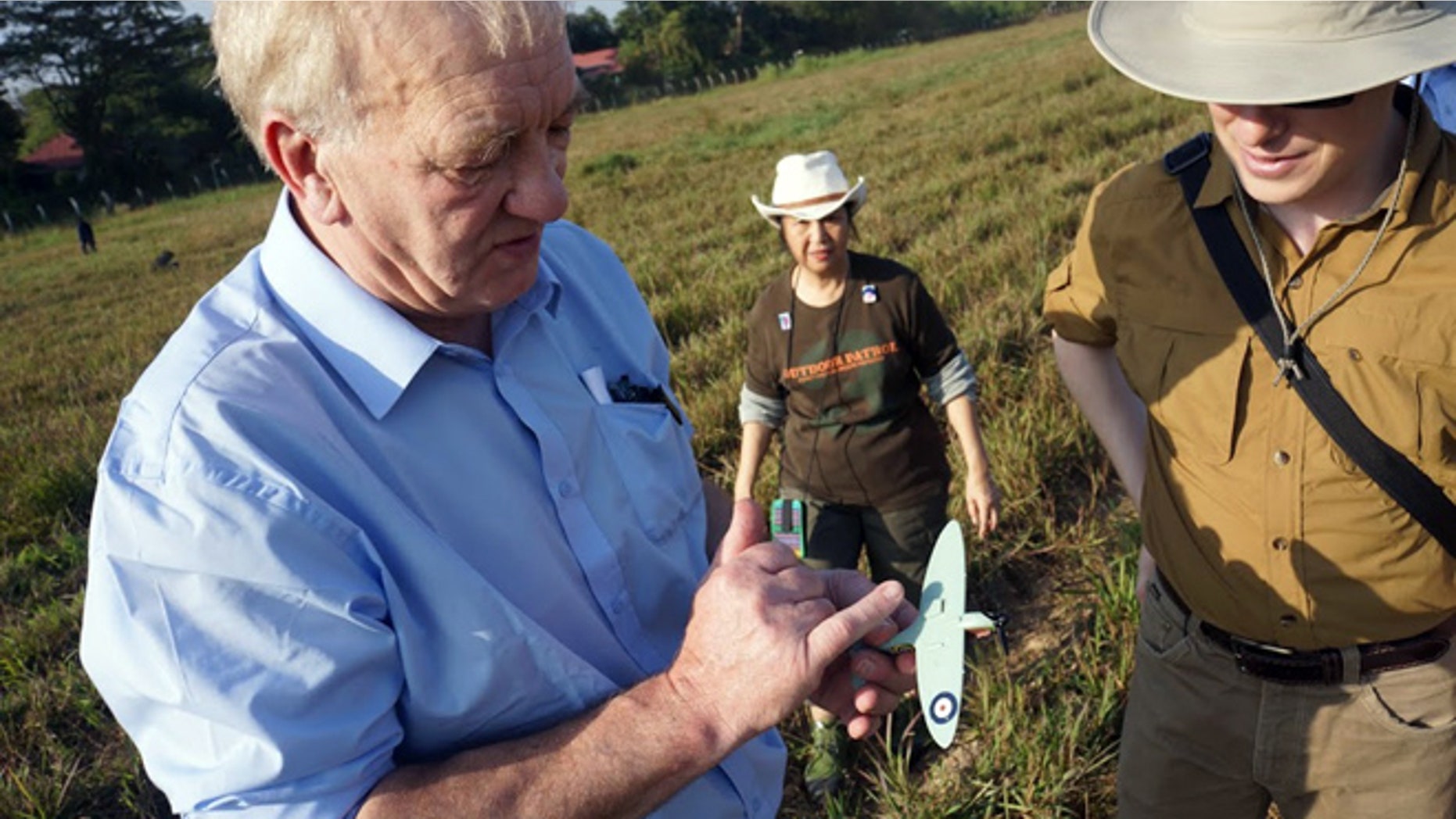 Jan. 7, 2013: British farmer and businessman David Cundall, left, leader of an archaeological excavation team of buried World War II Spitfires, accompanied by Tracy Spaight, director of special projects at Belarusian videogame company Wargaming.net, that backs the venture, shows a model of Spitfire as they inspect a field where they expected to find the aircraft underground.