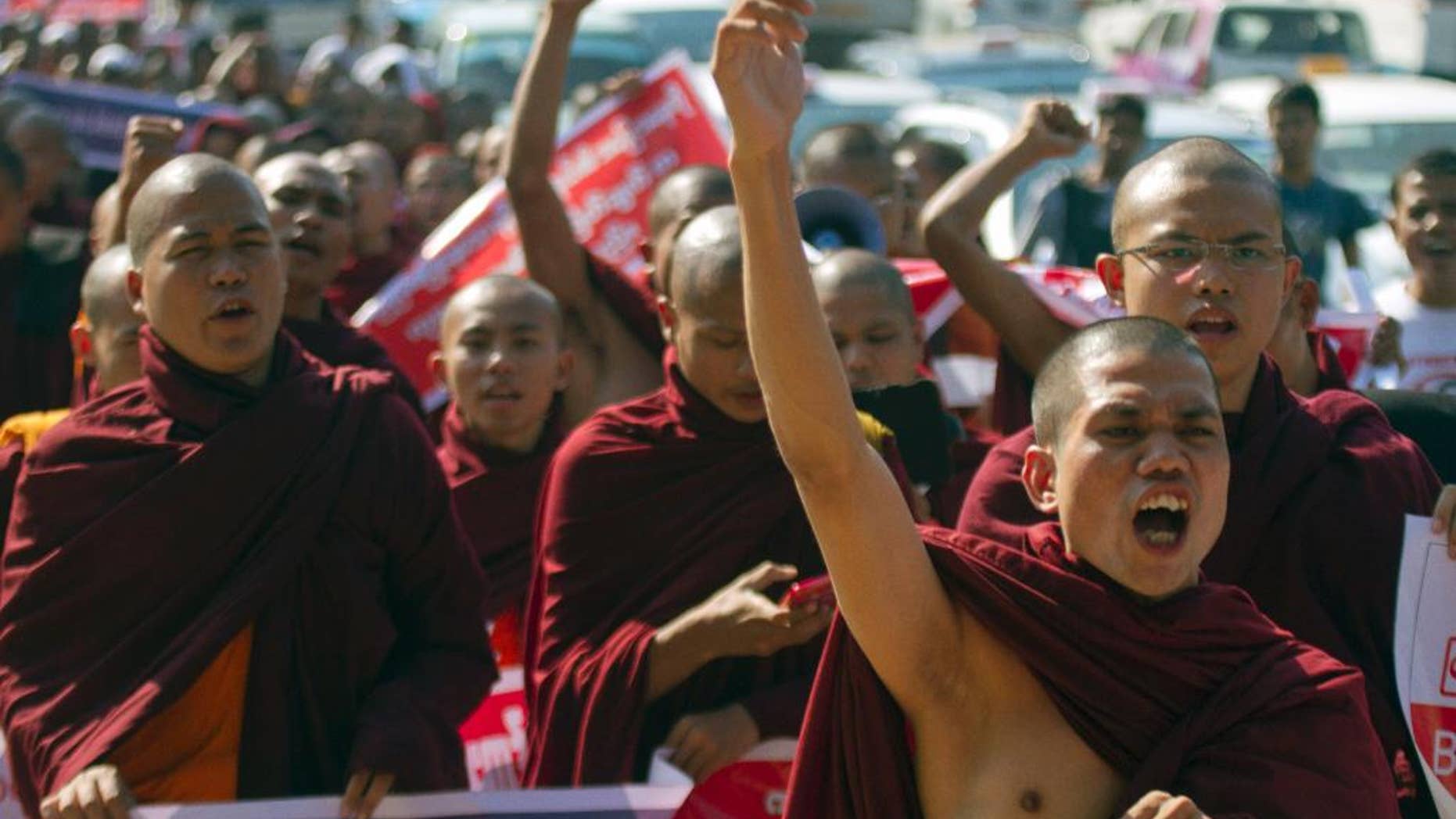 Myanmar Buddhist monks shout slogans as they march to protest against a resolution adopted by the UN General Assembly calling on Myanmar to grant citizenship to Rohingya, Friday, Jan.16, 2015, in Yangon, Myanmar. The United Nations General Assembly’s human rights committee passed a resolution last year, urging Myanmar to grant citizenship to the Rohingya, a stateless Muslim minority group. (AP Photo/Khin Maung Win)