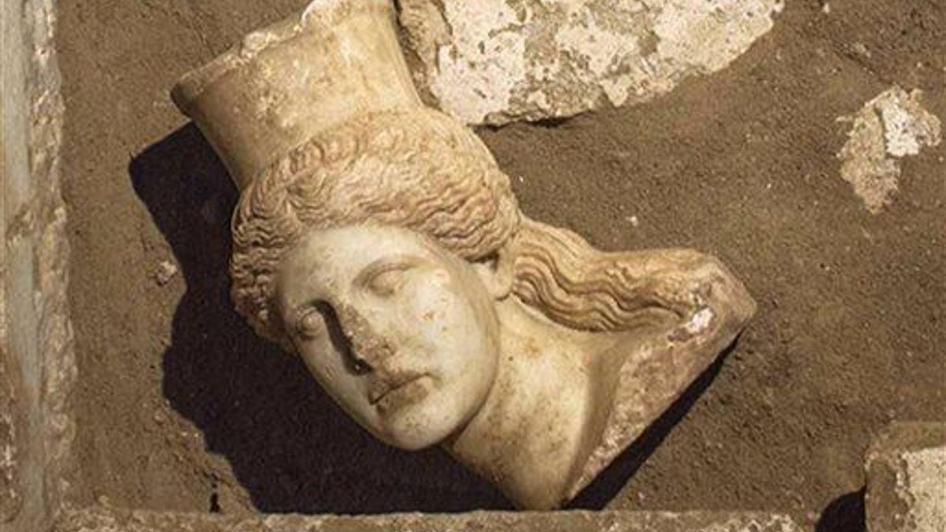 This picture provided by Greece's Culture Ministry, Oct. 20, 2014, shows the head of a marble sphinx, which adorned the entrance of a 4th-century-BC tomb under excavation at Amphipolis in Greece.