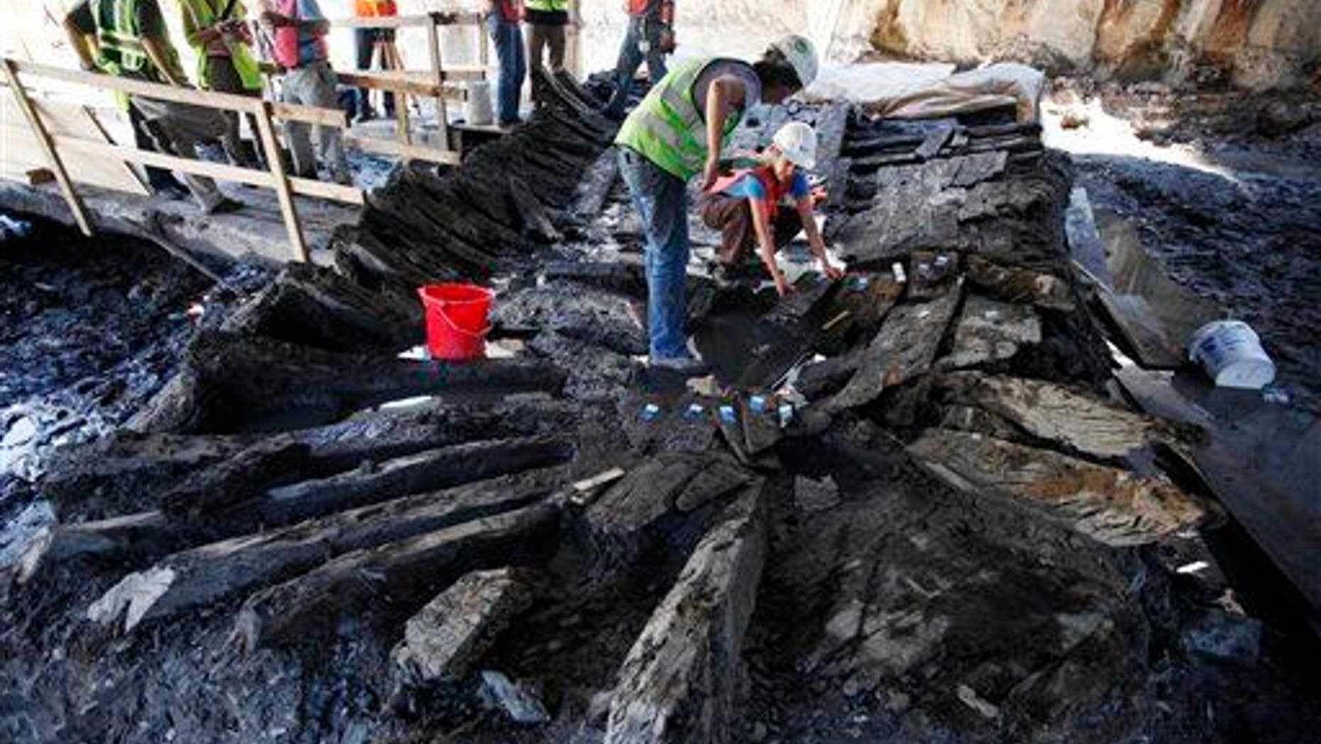Archeologists begin dismantling the remains of an 18th-century ship at the World Trade Center construction site in 2010 in New York.