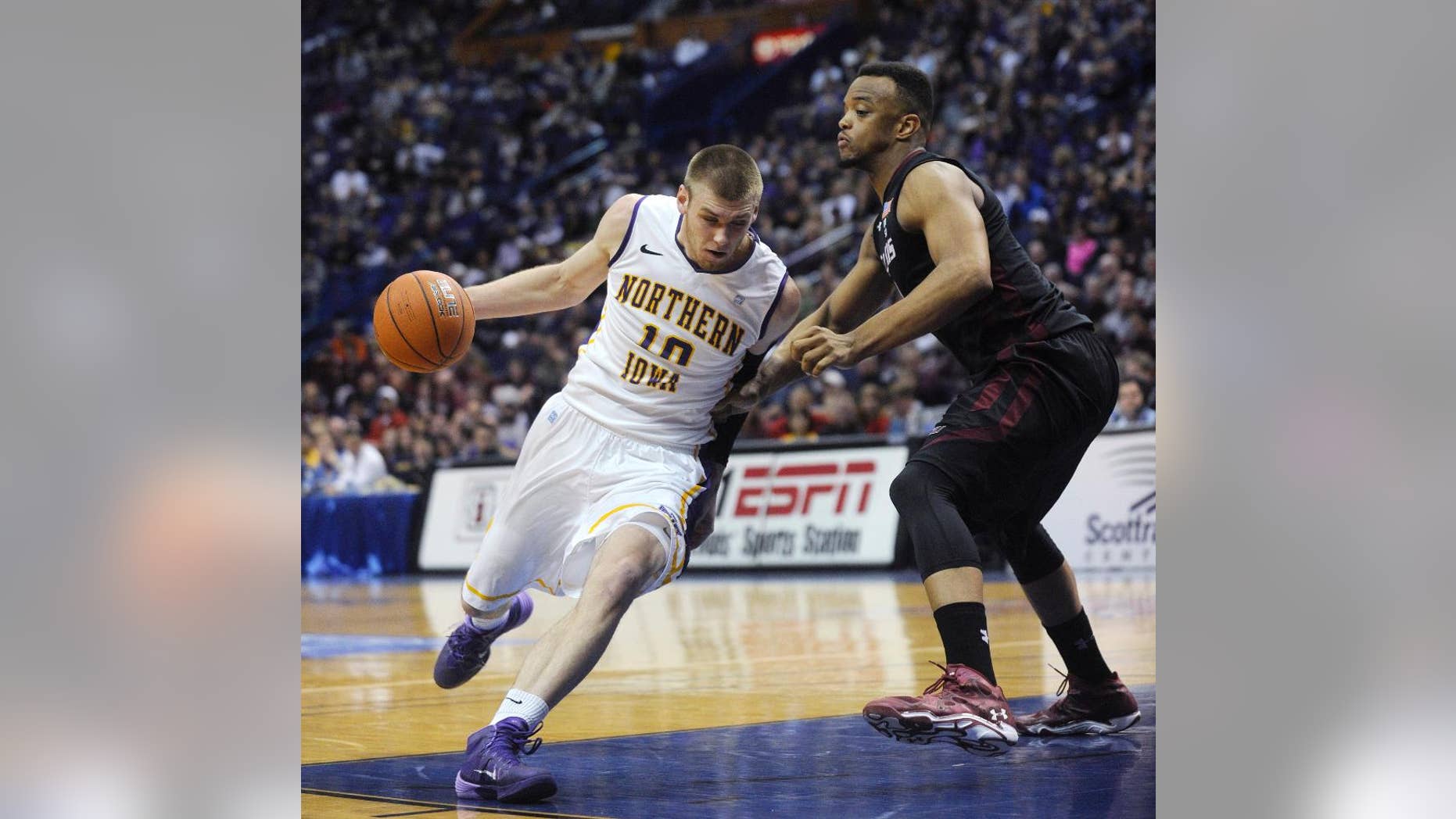 FILE - In this March 7, 2014, file photo, Northern Iowa's Seth Tuttle (10) drives past Southern Illinois' Davante Drinkard during the first half of an NCAA college basketball game in the quarterfinals of the Missouri Valley Conference men's tournament in St. Louis. Northern Iowa's hopes for reaching the NCAA tournament rest largely on the shoulders of Tuttle, a senior forward who ranks among the nation's most underrated big men. (AP Photo/Bill Boyce, File)