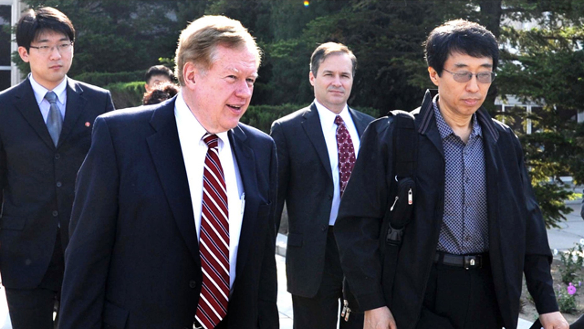 May 28, 2011: Robert King, left, U.S. special envoy for North Korean human rights issues, and U.S. citizen Eddie Jun, right, prepare to leave Pyongyang, North Korea.