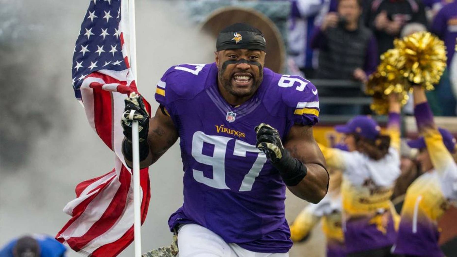 Sunday, November 23: Minnesota Vikings defensive end Everson Griffen carries the American flag on the field prior to the game against the Green Bay Packers at TCF Bank Stadium.