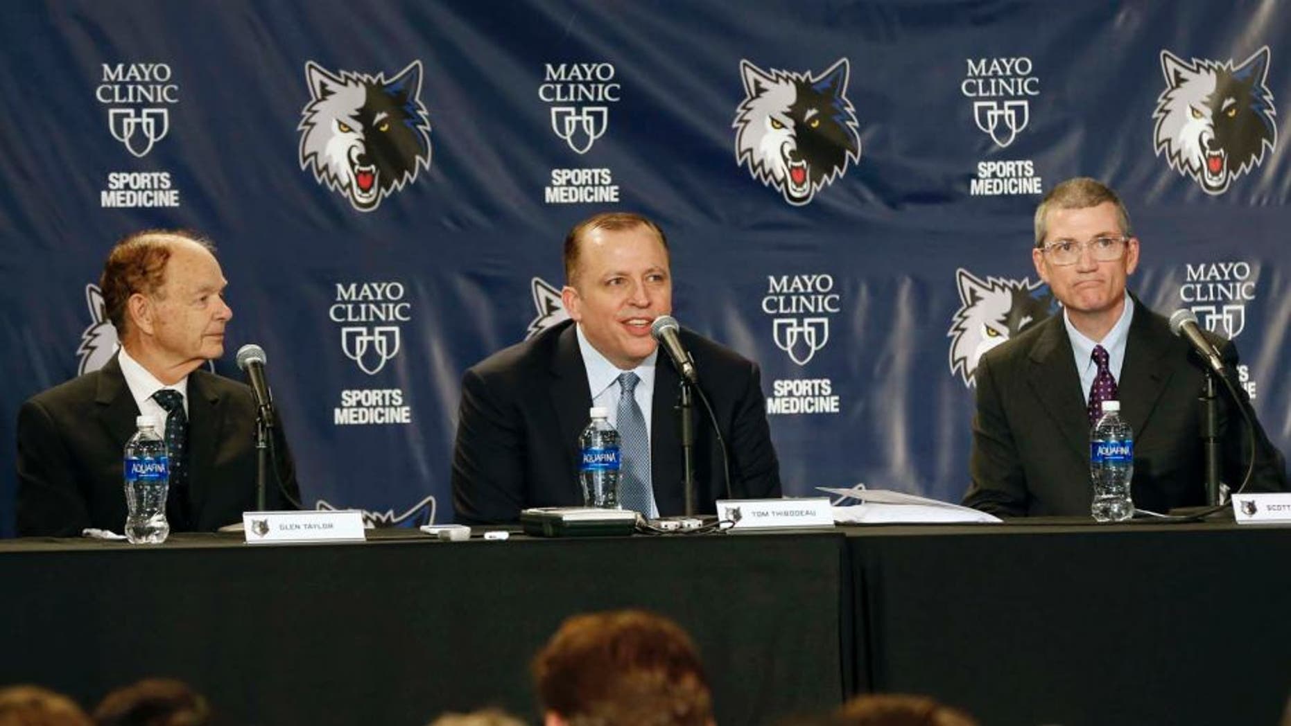Tuesday, April 26: Tom Thibodeau (center) addresses the media and a gathering of fans after he was introduced as the new Minnesota Timberwolves head coach. At left is Timberwolves owner Glen Taylor. At right is new general manager Scott Layden who was also introduced.
