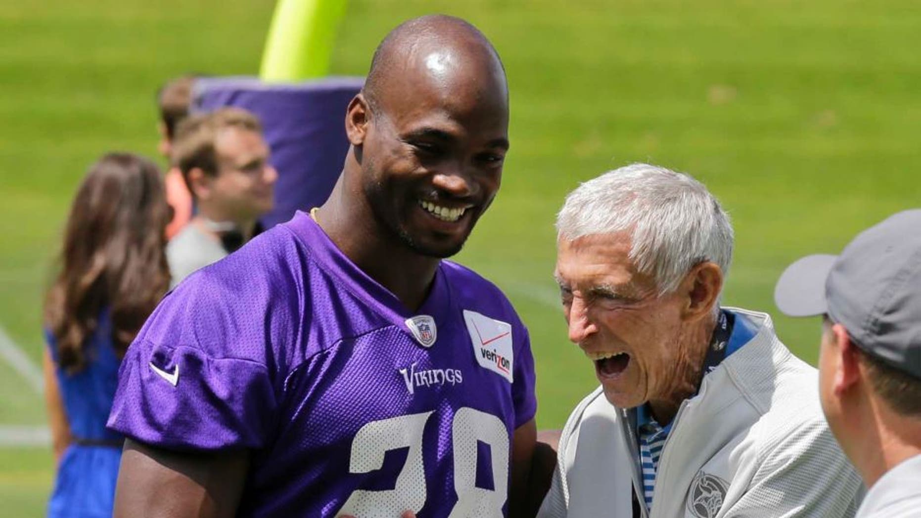 Thursday, June 18: Minnesota Vikings running back Adrian Peterson (left) laughs with former Vikings head coach Jerry Burns during minicamp in Eden Prairie, Minn.