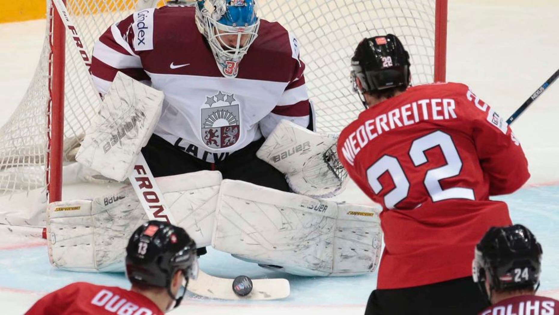 Wednesday, May 11, 2016: Switzerlandâs Nino Niederreiter scores against Latviaâs goalie Edgars Masalskis during the Ice Hockey World Championships Group A match between Switzerland and Latvia, in Moscow, Russia.