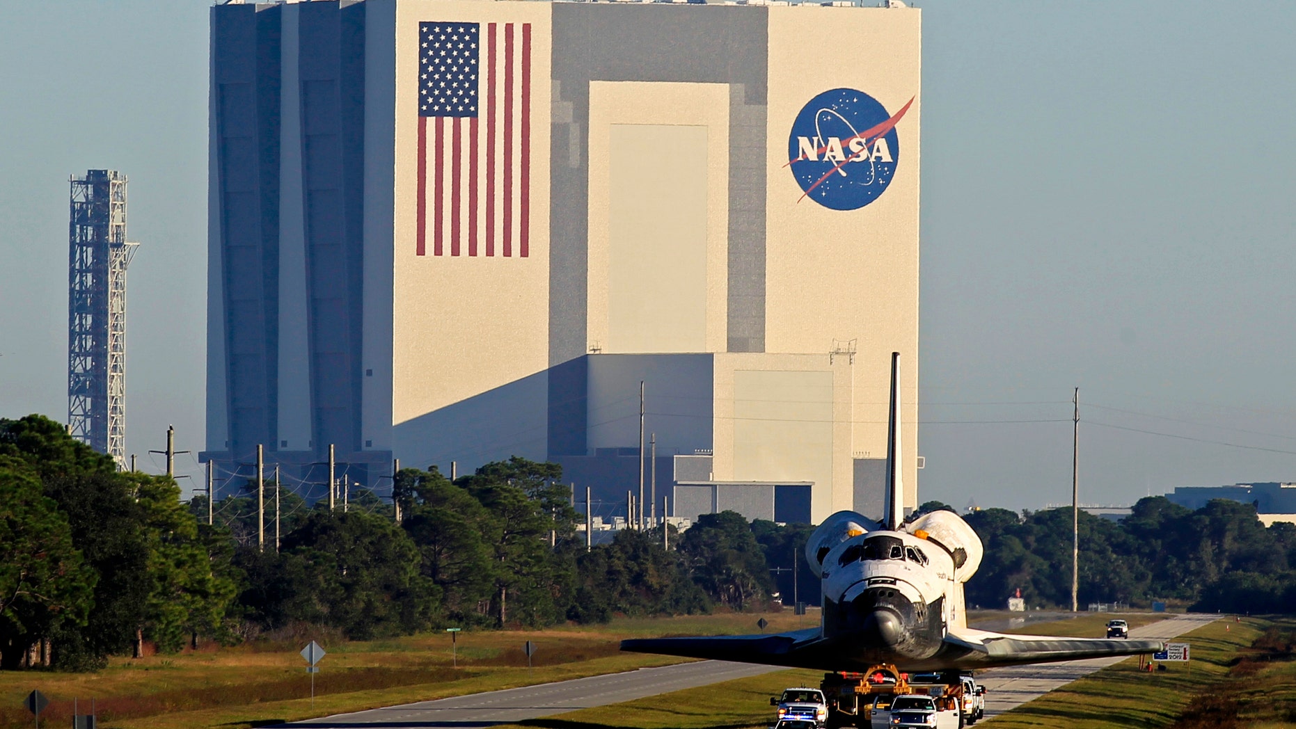 The space shuttle Atlantis leaves the Kennedy Space Center in Cape Canaveral, Florida November 2, 2012, heading towards its new home at the privately operated Kennedy Space Center Visitor Complex adjacent to the NASA spaceport. NASA's third and last surviving space shuttle moved to its retirement home on Friday after a 10-mile (16 km) road trip from the Kennedy Space Center in Florida. Atlantis, which ended the 30-year-old space shuttle program with a final flight last year, will be the star attraction of a new $100 million exhibit at the Kennedy Space Center Visitor Complex. REUTERS/Joe Skipper (UNITED STATES - Tags: SCIENCE TECHNOLOGY) - RTR39WK9