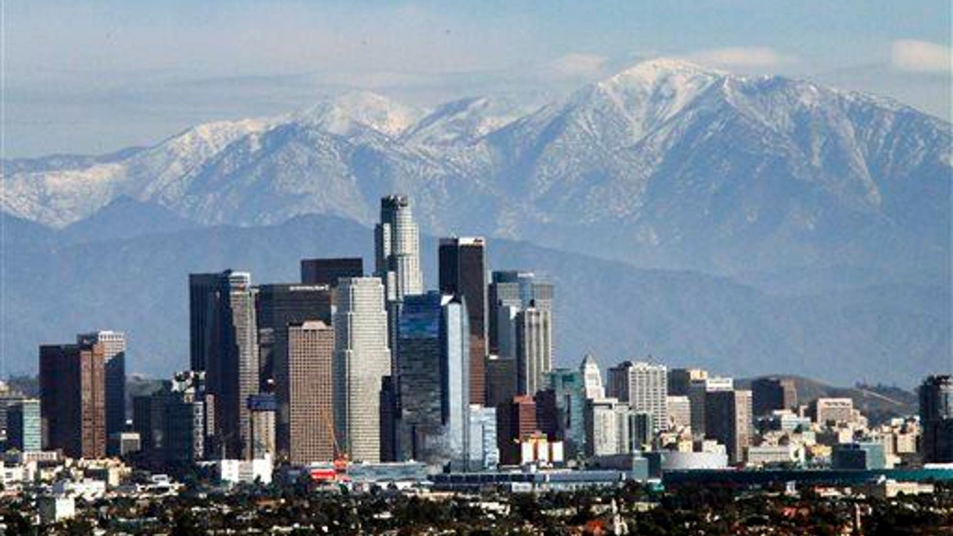 The snow-capped San Gabriel Mountains provide a backdrop to the downtown Los Angeles skyline as seen from Kenneth Hahn State Recreation Area in Baldwin Hills, Wednesday, Dec. 31, 2014.
