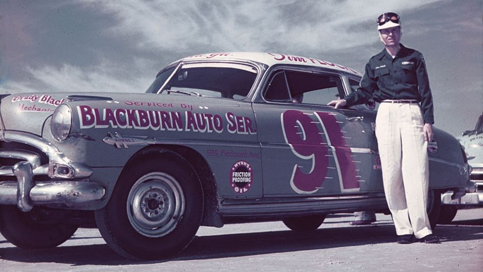 DAYTONA BEACH, FL - FEBRUARY 1952: Tim Flock poses with the Ted Chester-owned Blackburn Auto Service Hudson Hornet before NASCAR Cup racing activity on the Daytona Beach-Road Course. Flock drove for Chester from 1951 through 1953, winning 10 races and the 1952 Cup championship. (Photo by ISC Images & Archives via Getty Images)