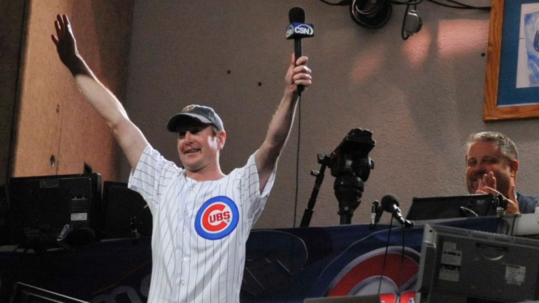 CHICAGO, IL - SEPTEMBER 19: NASCAR driver Kurt Busch sings take me out to the ball game during the Milwaukee Brewers Chicago Cubs game on September 19, 2011 at Wrigley Field in Chicago, Illinois. (Photo by David Banks/Getty Images)