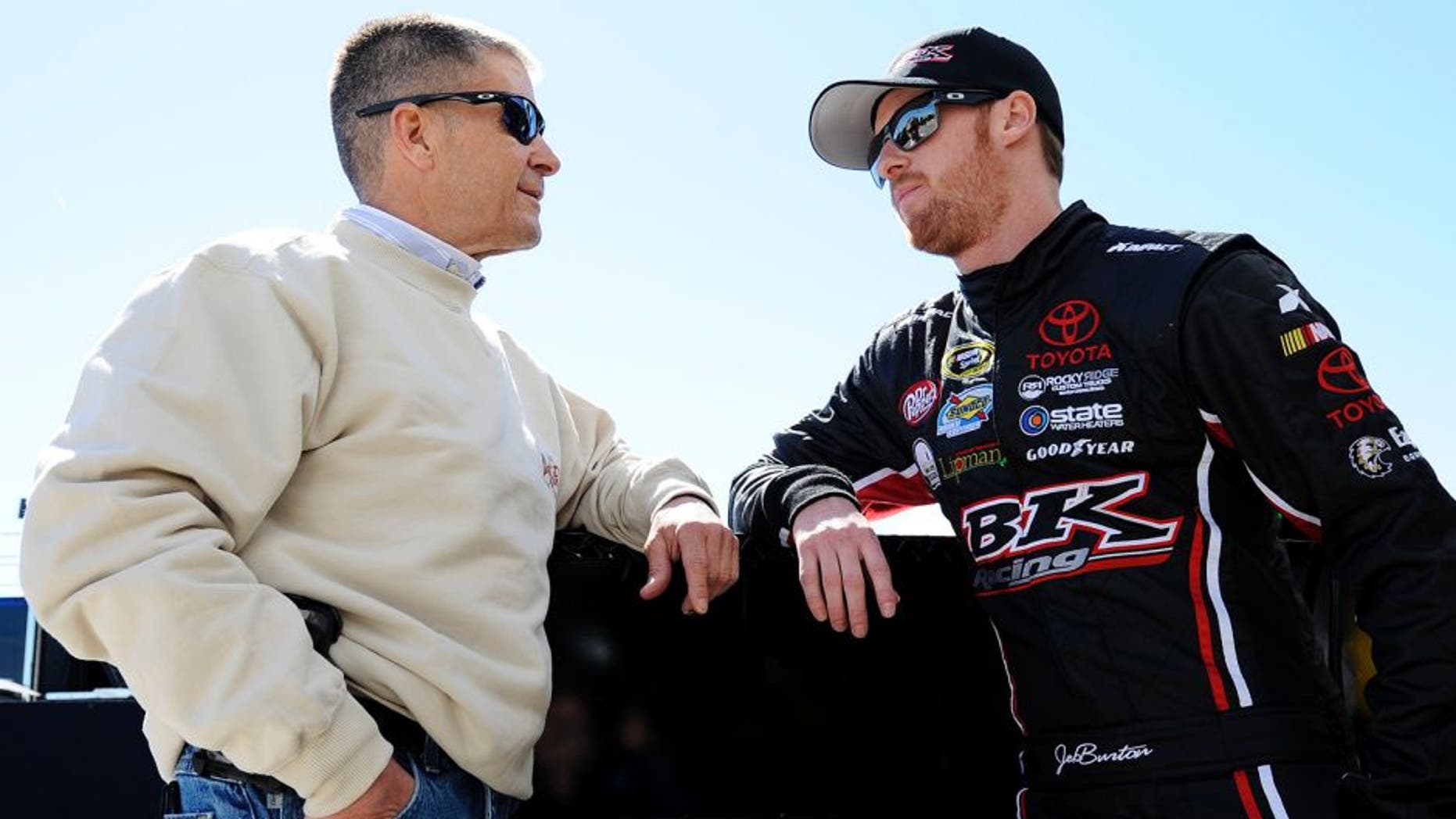 DAYTONA BEACH, FL - FEBRUARY 19: Jeb Burton, driver of the #26 LiveDeal.com Download the App Toyota, talks to his father Ward Burton in the garage area during practice for the NASCAR Sprint Cup Series 57th Annual Daytona 500 at Daytona International Speedway on February 19, 2015 in Daytona Beach, Florida. (Photo by Jared C. Tilton/Getty Images)