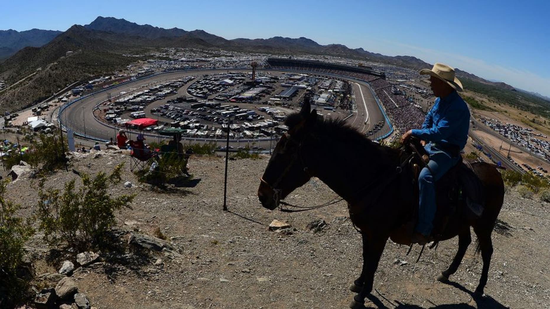 A race fan on horseback looks on during the NASCAR Sprint Cup Series CampingWorld.com 500 at Phoenix International Raceway on March 15, 2015 in Avondale, Arizona.