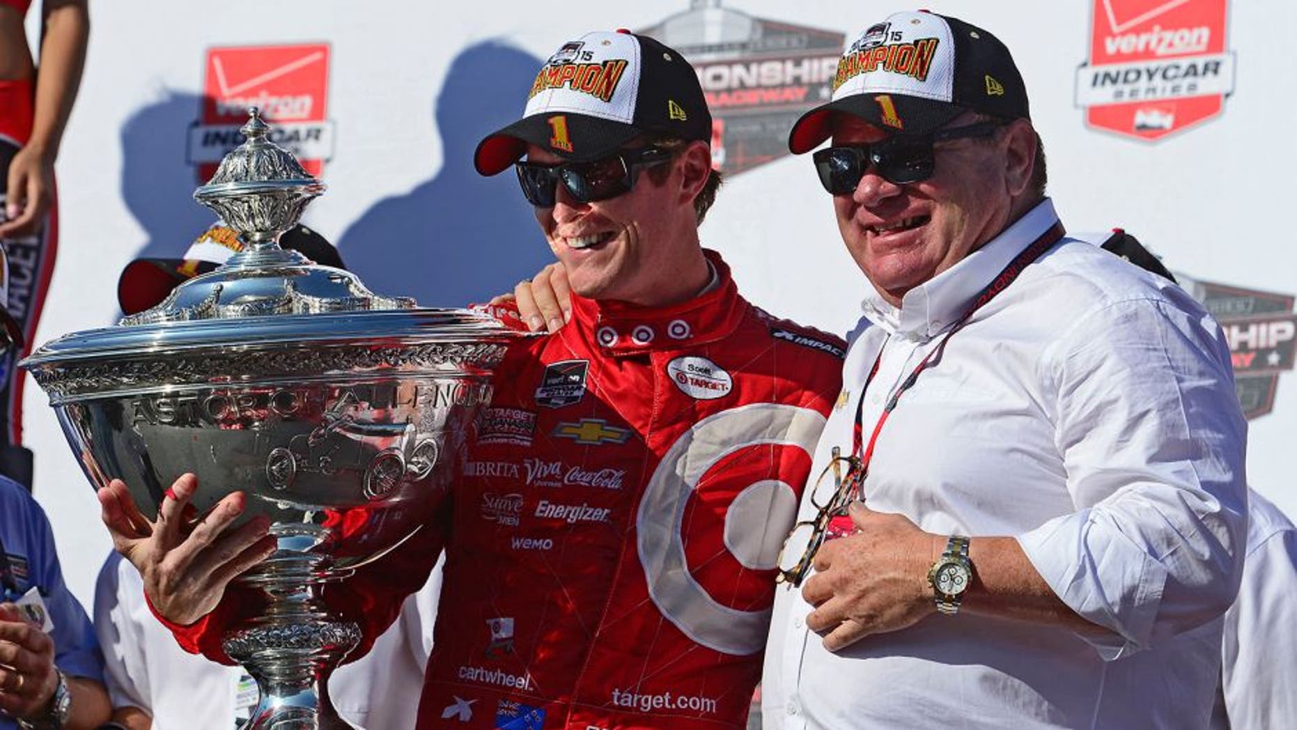 SONOMA, CA - AUGUST 30: Scott Dixon of New Zealand driver of the #9 Target Chip Ganassi Racing Chevrolet Dallara and team owner Chip Ganassi pose with the Championship Trophy presentation stage after winning the Verizon IndyCar Series GoPro Grand Prix of Sonoma at Sonoma Raceway on August 30, 2015 in Sonoma, California. (Photo by Robert Laberge/Getty Images)