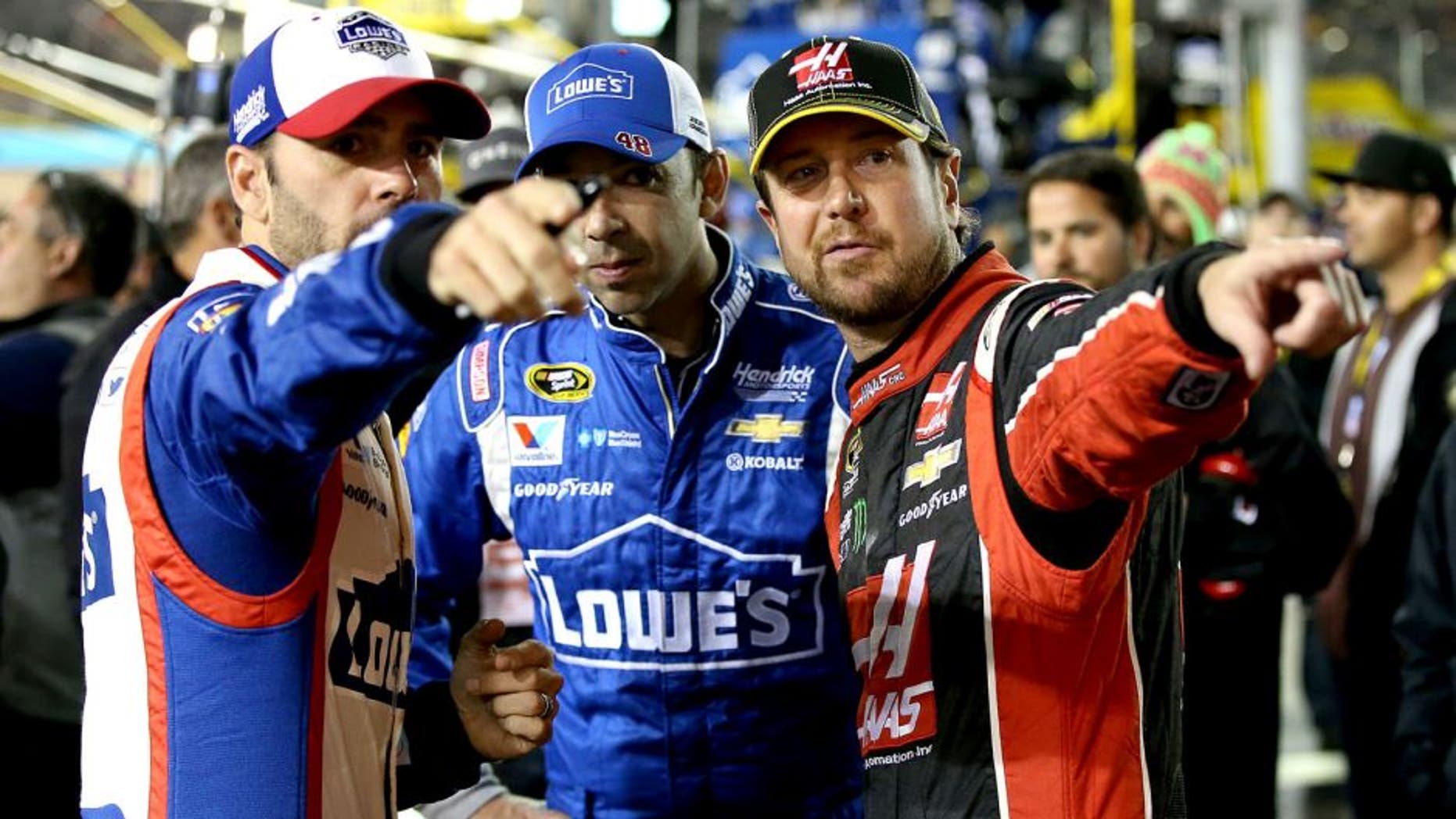 AVONDALE, AZ - NOVEMBER 15: (L-R) Jimmie Johnson, driver of the #48 Lowe's Patriotic Chevrolet, crew chief Chad Knaus and Kurt Busch, driver of the #41 Haas Automation Chevrolet, talk on pit road before the NASCAR Sprint Cup Series Quicken Loans Race for Heroes 500 at Phoenix International Raceway on November 15, 2015 in Avondale, Arizona. (Photo by Sean Gardner/Getty Images)