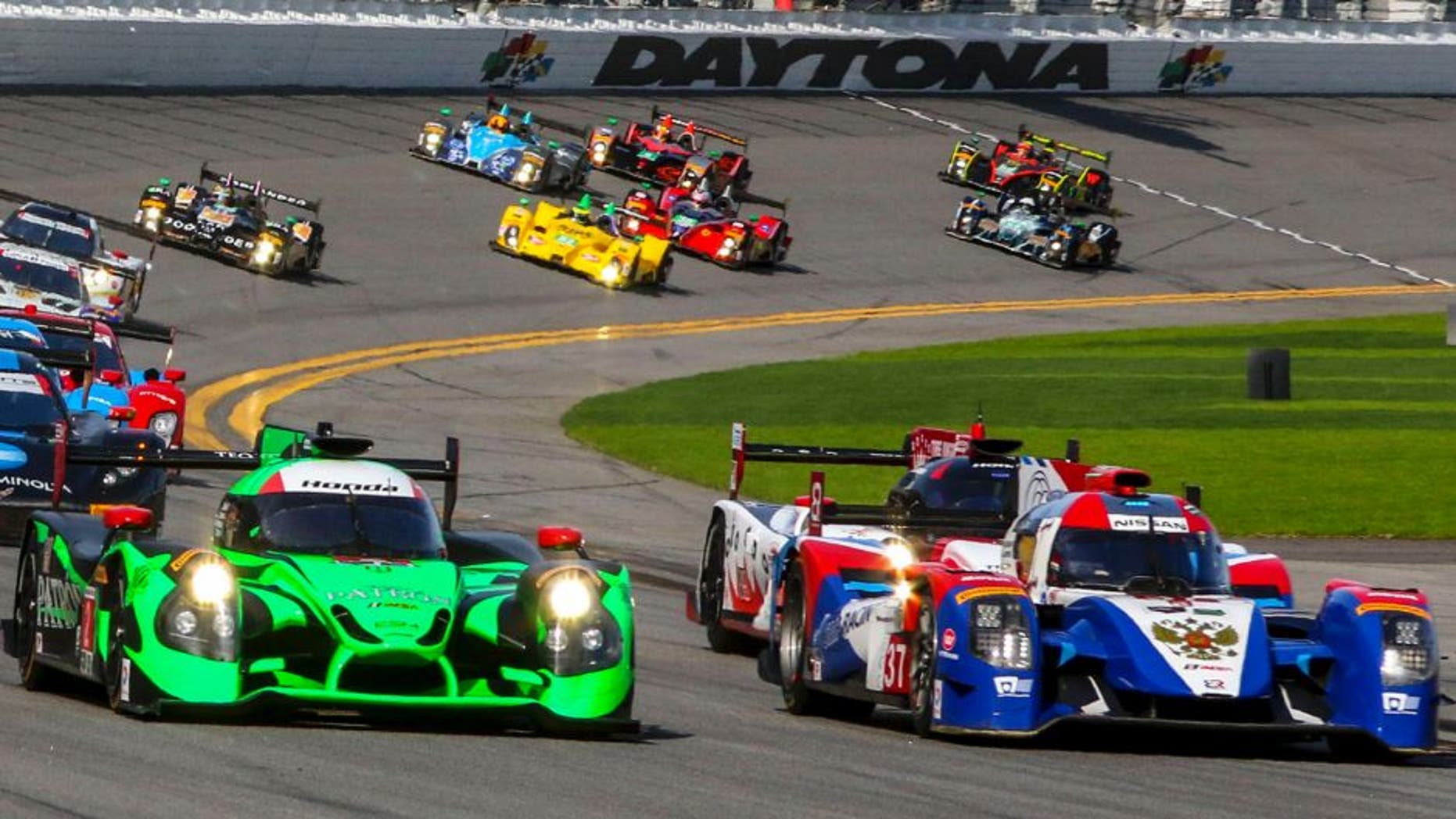 DAYTONA BEACH, FL - JANUARY 30: Prototype cars race into turn one at the start of the Rolex 24 at Daytona at Daytona International Speedway on January 30, 2016 in Daytona Beach, Florida. (Photo by Brian Cleary/Getty Images)