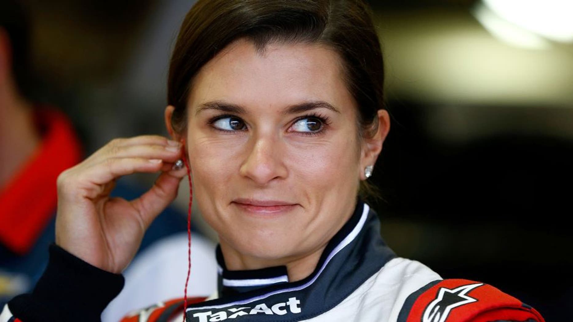 FONTANA, CA - MARCH 19: Danica Patrick, driver of the #10 TaxACT Chevrolet, adjusts her equipment in the garage area during practice for the NASCAR Sprint Cup Series Auto Club 400 at Auto Club Speedway on March 19, 2016 in Fontana, California. (Photo by Jonathan Ferrey/Getty Images)
