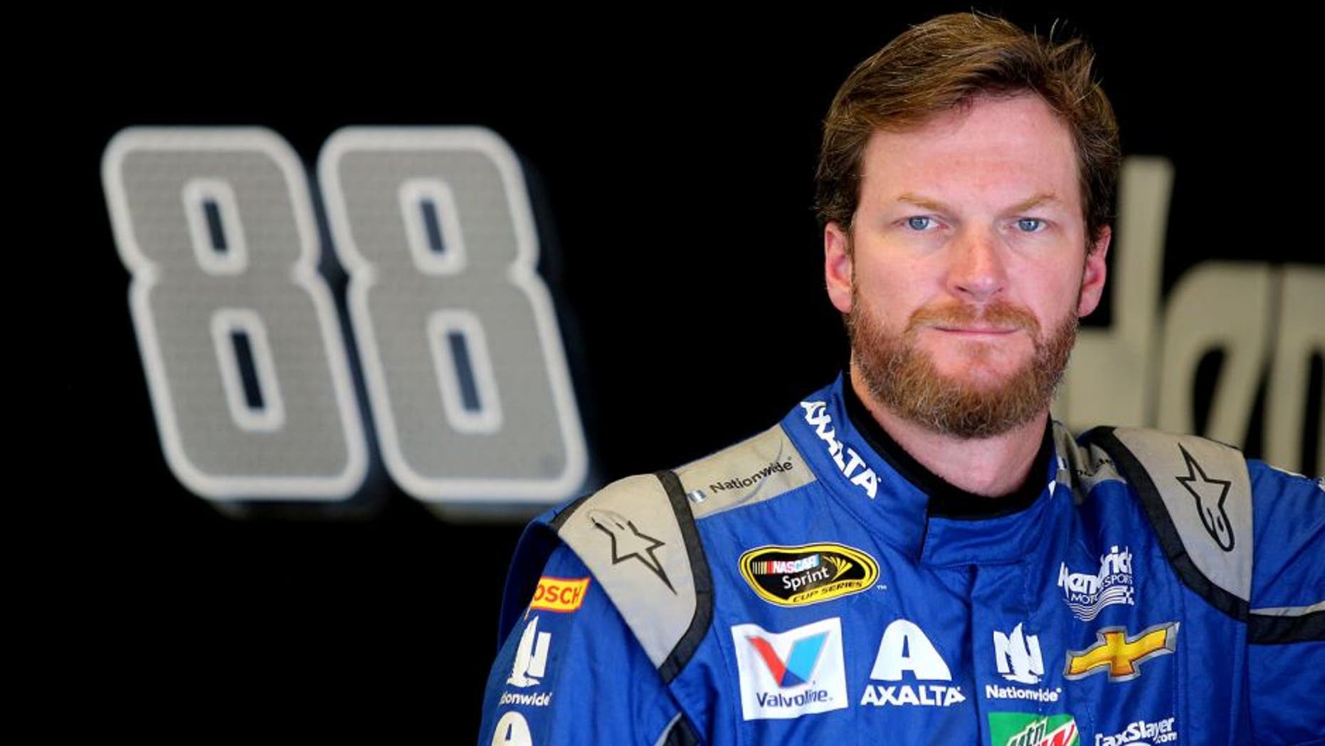 DAYTONA BEACH, FL - JUNE 30: Dale Earnhardt Jr., driver of the #88 Nationwide Chevrolet, stands in the garage area during practice for the NASCAR Sprint Cup Series Coke Zero 400 at Daytona International Speedway on June 30, 2016 in Daytona Beach, Florida. (Photo by Jerry Markland/Getty Images)