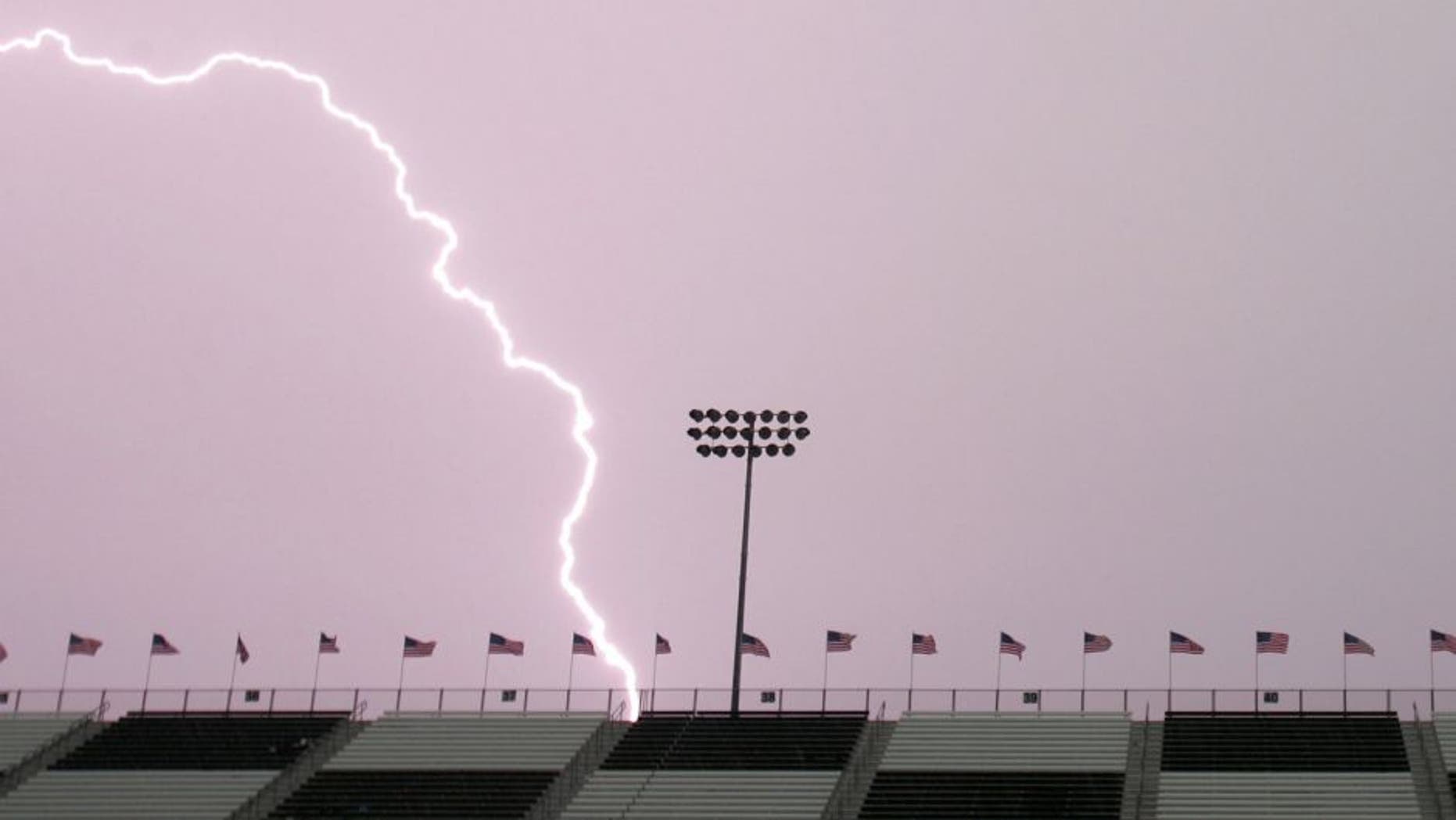MADISON, IL - JULY 29: Lightning hits behind the front stretch grandstands during a thunderstorm before the start of the NASCAR Busch Series Busch Silver Celebration 250 presented by Shop 'n Save on July 29, 2006 at the Gateway International Raceway in Madison, Illinois. (Photo by Robert Laberge/Getty Images for NASCAR)