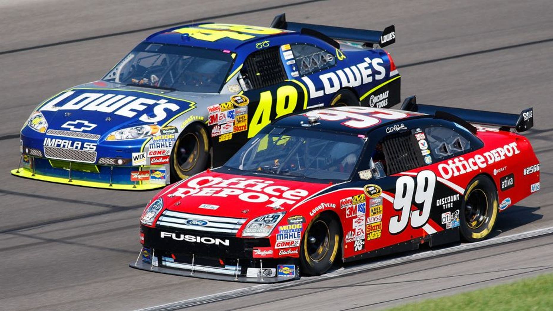 KANSAS CITY, KS - SEPTEMBER 28: Carl Edwards, driver of the #99 Office Depot Ford, and Jimmie Johnson, driver of the #48 Lowe's Chevrolet, drive during the NASCAR Sprint Cup Series Camping World RV 400 at Kansas Speedway on September 28, 2008 in Kansas City, Kansas. (Photo by John Harrelson/Getty Images for NASCAR)