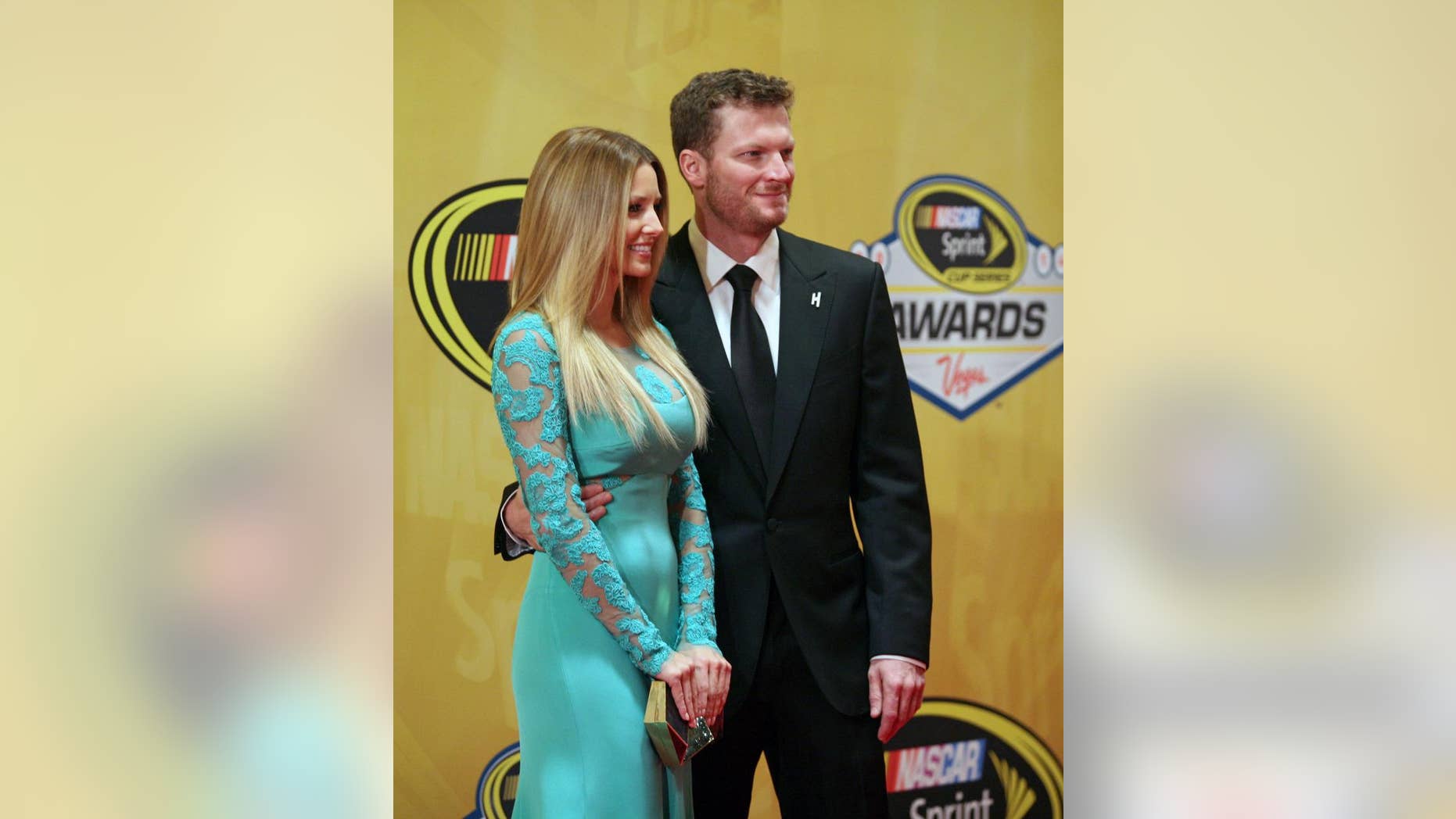 Dale Earnhardt Jr., right, and his girlfriend Amy Reimann stand on the red carpet prior to the NASCAR Sprint Cup Series Awards at Wynn Las Vegas hotel-casino Friday, Dec. 5, 2014, in Las Vegas. (AP Photo/Ronda Churchill)