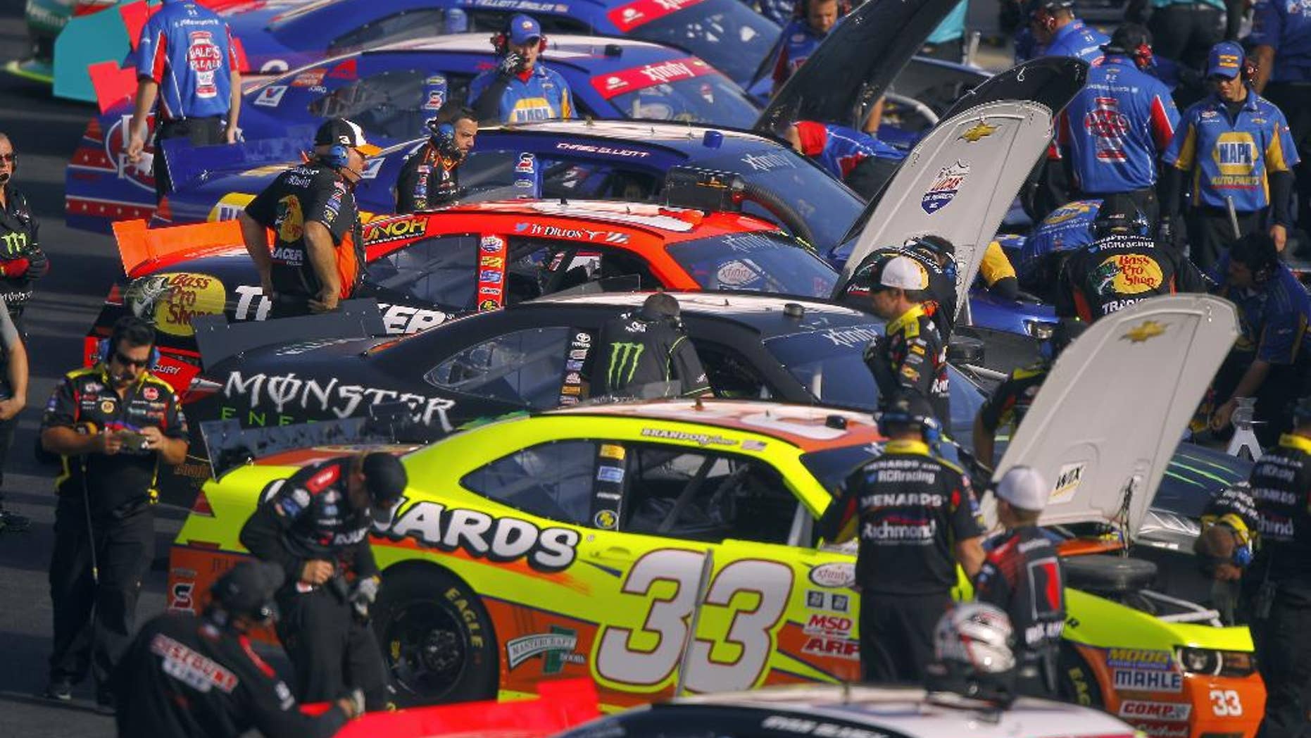 Crew members work on cars during practice for the Food City 300 NASCAR Xfinity Series auto race on Friday, Aug. 21, 2015, in Bristol, Tenn. (AP Photo/Wade Payne)