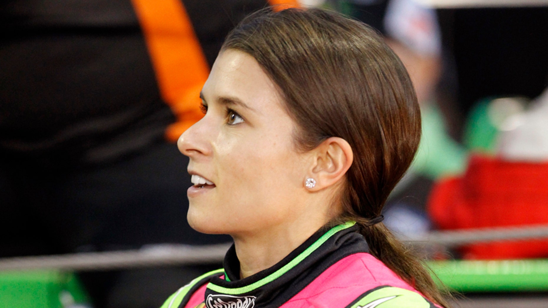 Danica Patrick talks to a crew member before qualifying for Saturday's NASCAR Bank of America Sprint Cup series auto race at Charlotte Motor Speedway in Concord, N.C., Thursday, Oct. 9, 2014. (AP Photo/Terry Renna)
