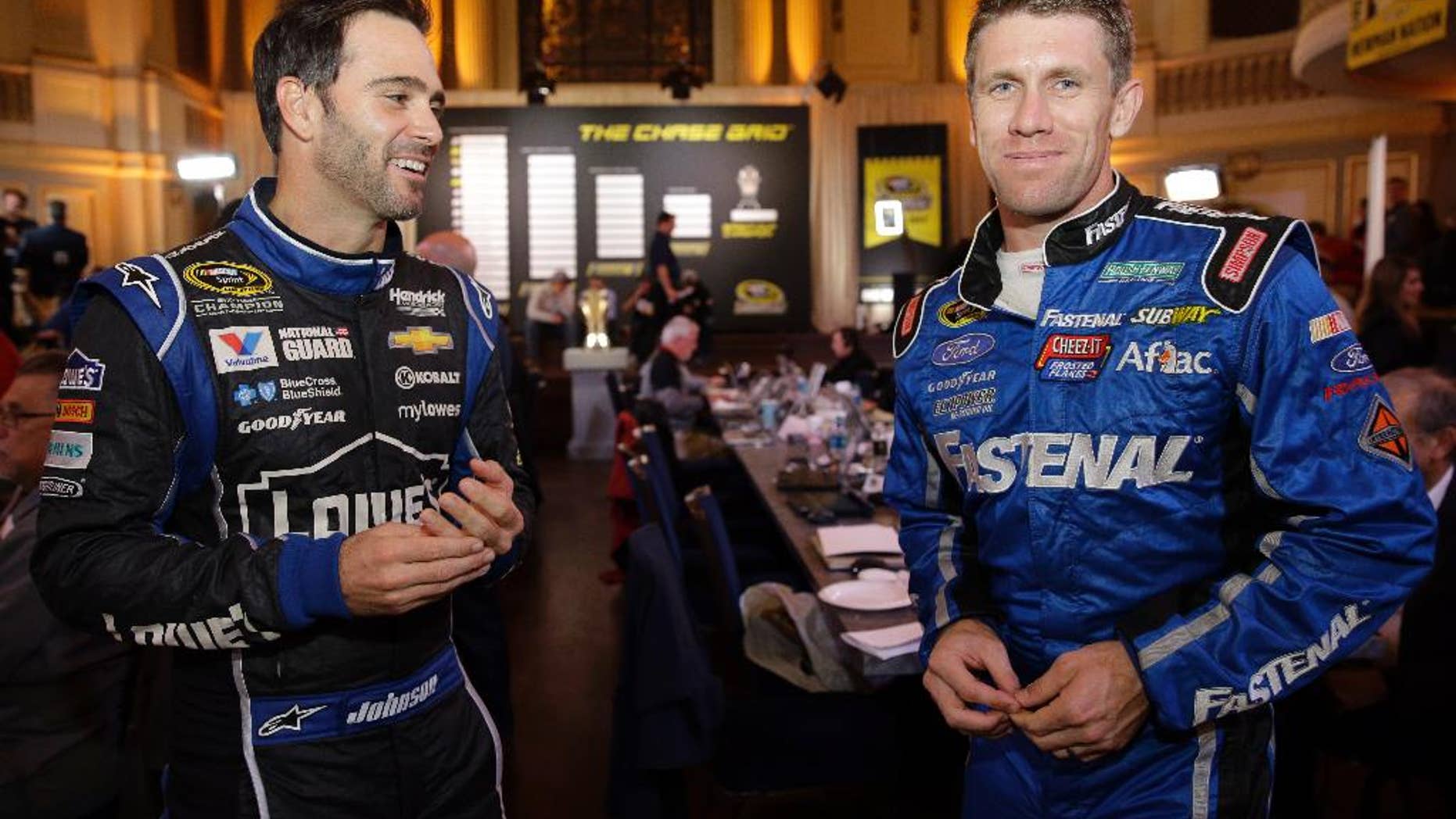 Jimmie Johnson, left, and Carl Edwards chat during the NASCAR Sprint Cup media day in Chicago, Thursday, Sept. 11, 2014. The 16 drivers in the Chase for the Sprint Cup championship took part in the event. The opening race in the Chase is at Chicagoland Speedway on Sunday in Joliet, Ill. (AP Photo/Nam Y. Huh)