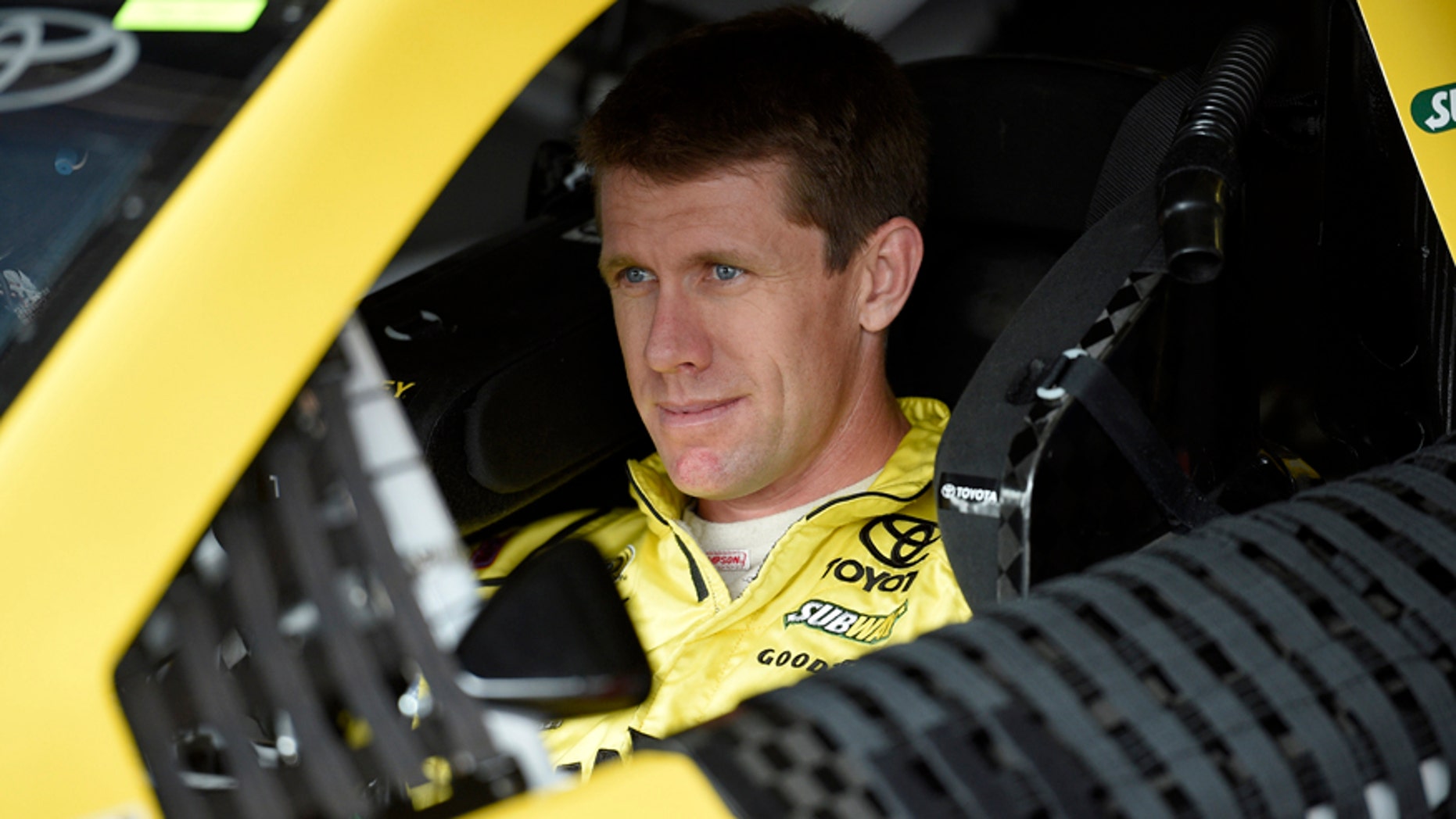 Carl Edwards looks out from his car before practice, Friday, May 29, 2015, for Sunday's NASCAR Sprint Cup series auto race at Dover International Speedway in Dover, Del. (AP Photo/Nick Wass)