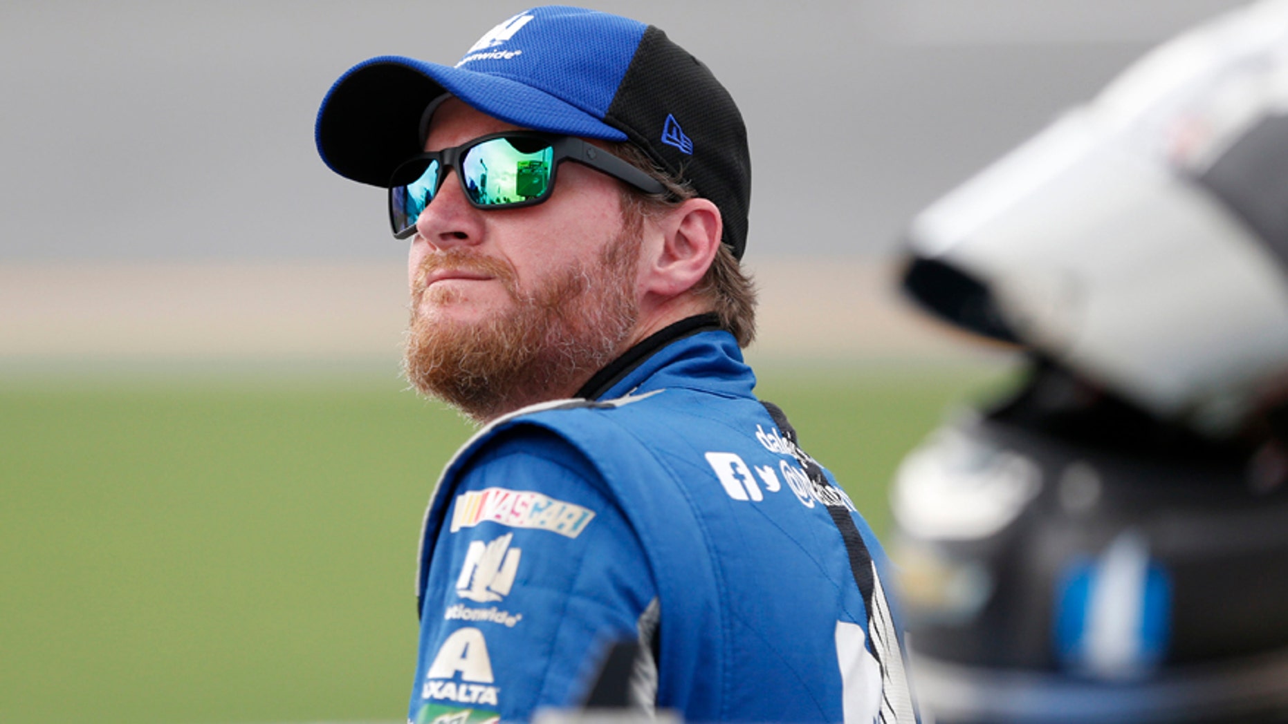 File-This July 1, 2016, file photo shows Dale Earnhardt Jr. watching the leader-board during qualifying for a NASCAR Sprint Cup auto race at Daytona International Speedway in Daytona Beach, Fla. (AP Photo/Wilfredo Lee, File)