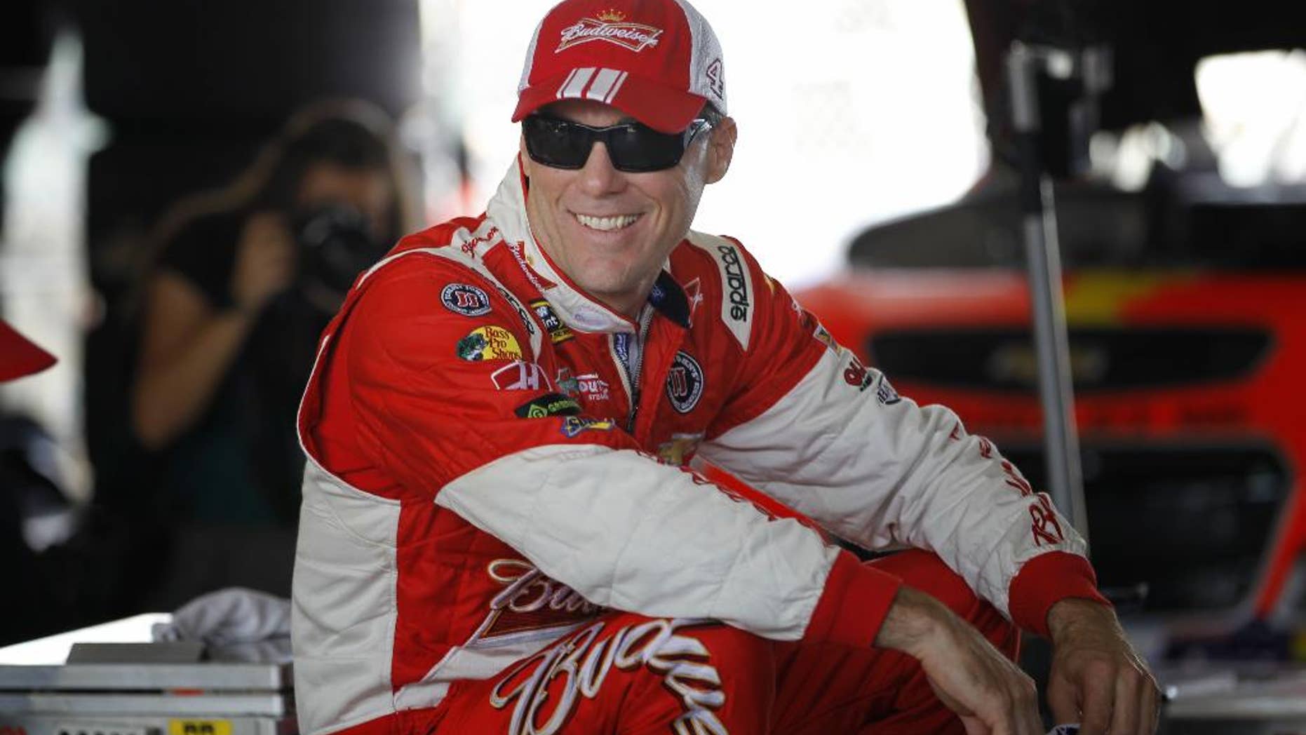 Driver Kevin Harvick sits in his garage as he prepares for Sunday's NASCAR Sprint Cup sereis auto race, Saturday, Nov. 15, 2014 in Homestead, Fla. (AP Photo/Terry Renna)