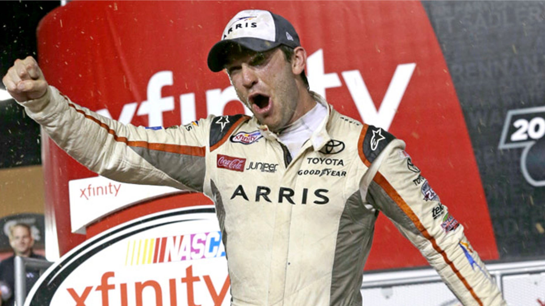 Daniel Suarez celebrates after wining the NASCAR Xfinity auto race and season title, Saturday, Nov. 19, 2016, in Homestead, Fla. (AP Photo/Terry Renna)