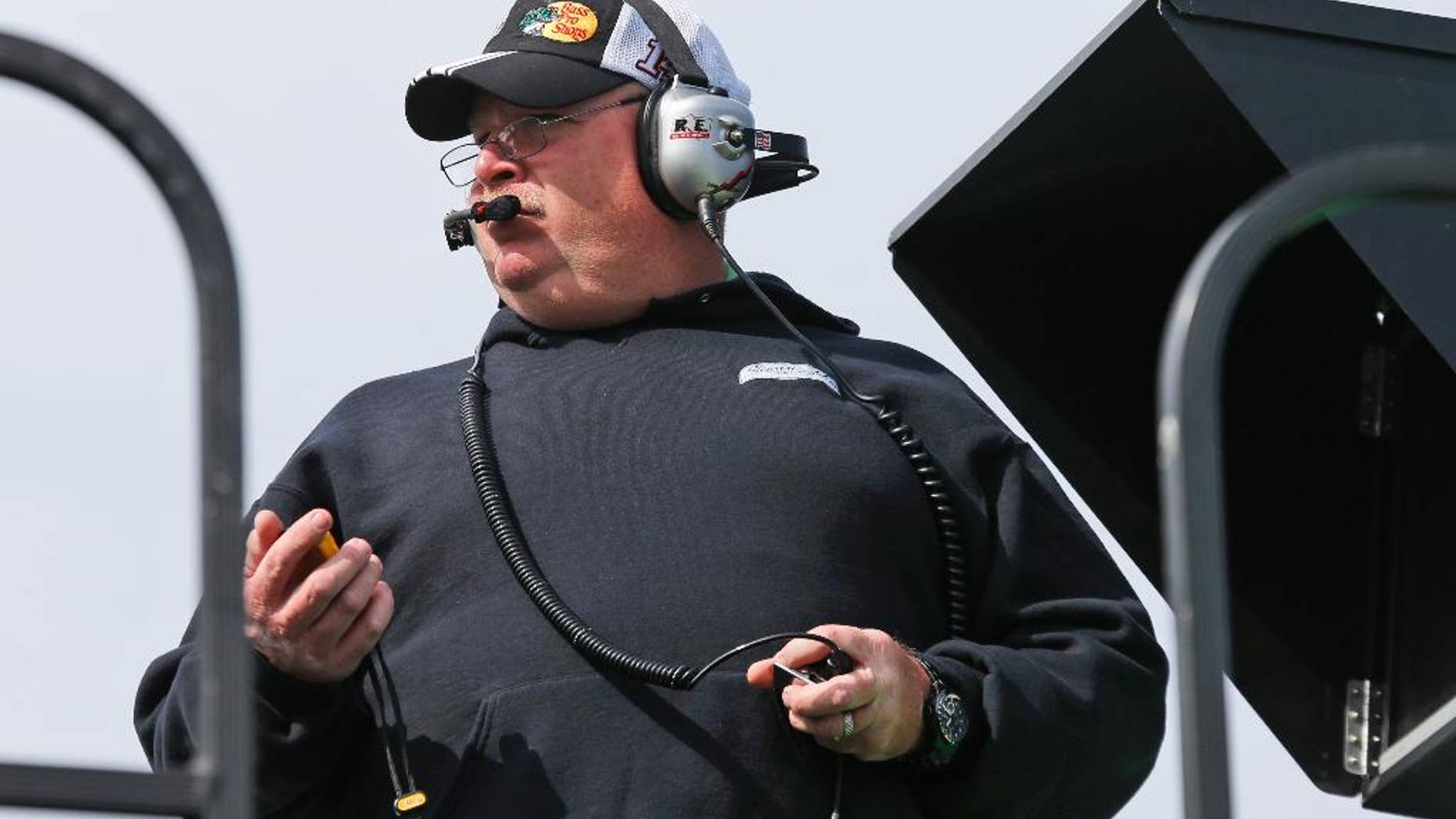 Tony Gibson, crew chief for Danica Patrick, times a practice run on top of the hauler during practice for Sunday's NASCAR Sprint Cup Series auto race at Martinsville Speedway in Martinsville, Va., Friday, Oct. 24, 2014. Gibson will change to be crew chief for Kurt Busch next week. (AP Photo/Steve Helber)