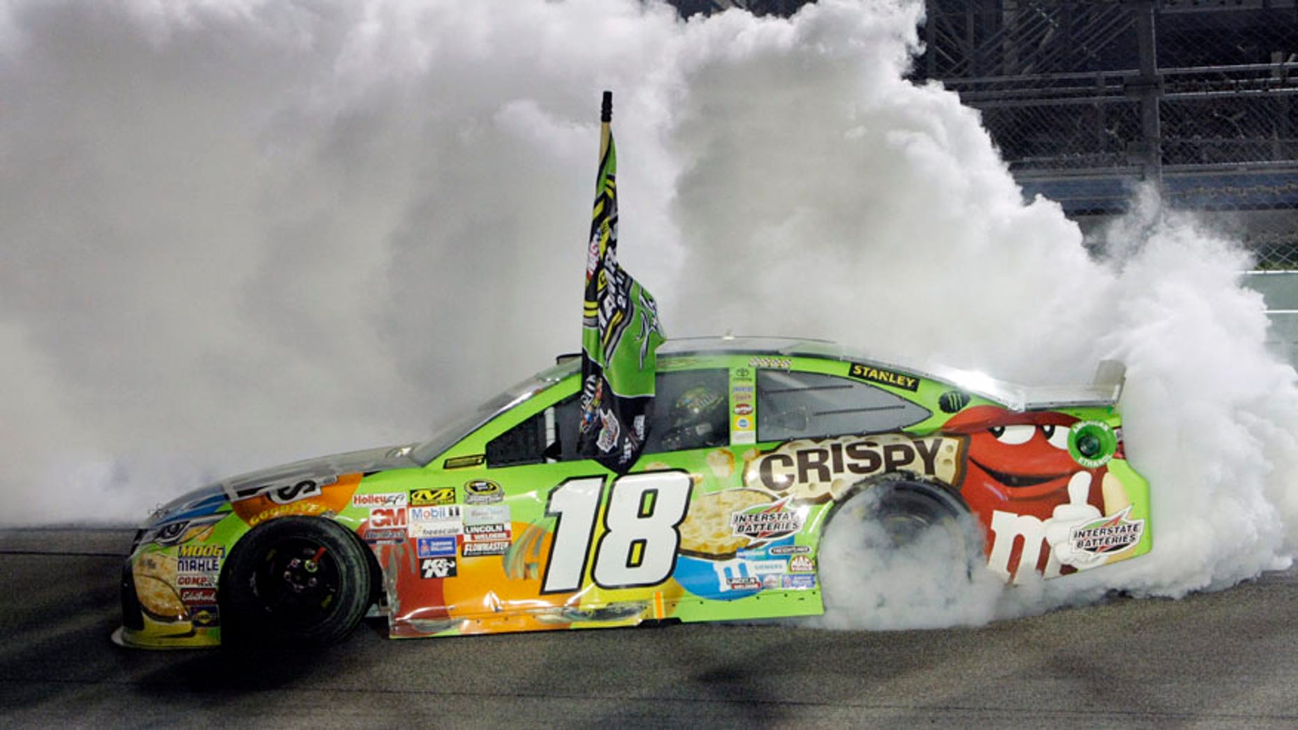 FILE - In this Nov. 22, 2015, file photo, Kyle Busch does a burnout after winning the NASCAR Sprint Cup Series auto race and the season title, at Homestead-Miami Speedway in Homestead, Fla. With four-time champion Jeff Gordon retired and three-time champ Tony Stewart sidelined with a broken back, the NASCAR season begins with a much different look and a new rules package. (AP Photo/Darryl Graham)