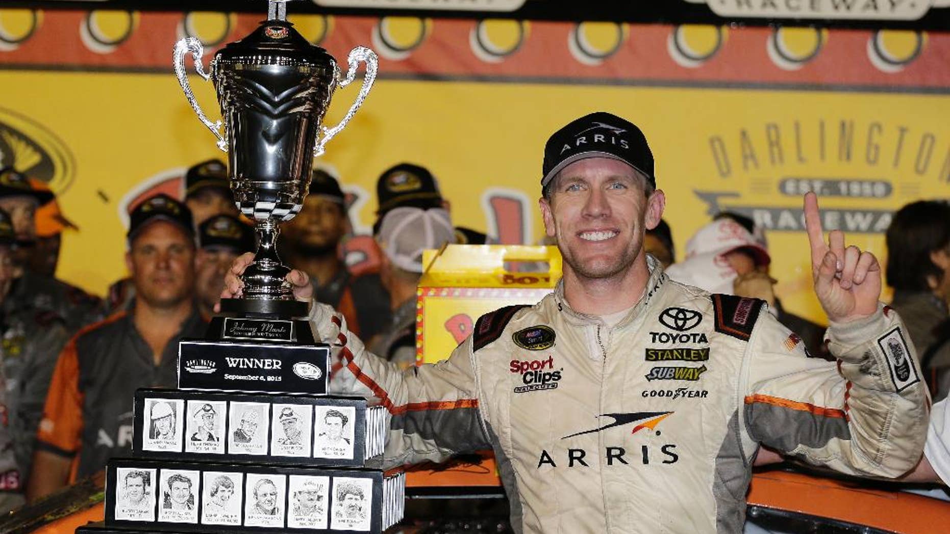 Carl Edwards celebrates in victory lane after winning a NASCAR Sprint Cup auto race at Darlington Raceway in Darlington, S.C., Monday, Sept. 7, 2015. (AP Photo/Terry Renna)