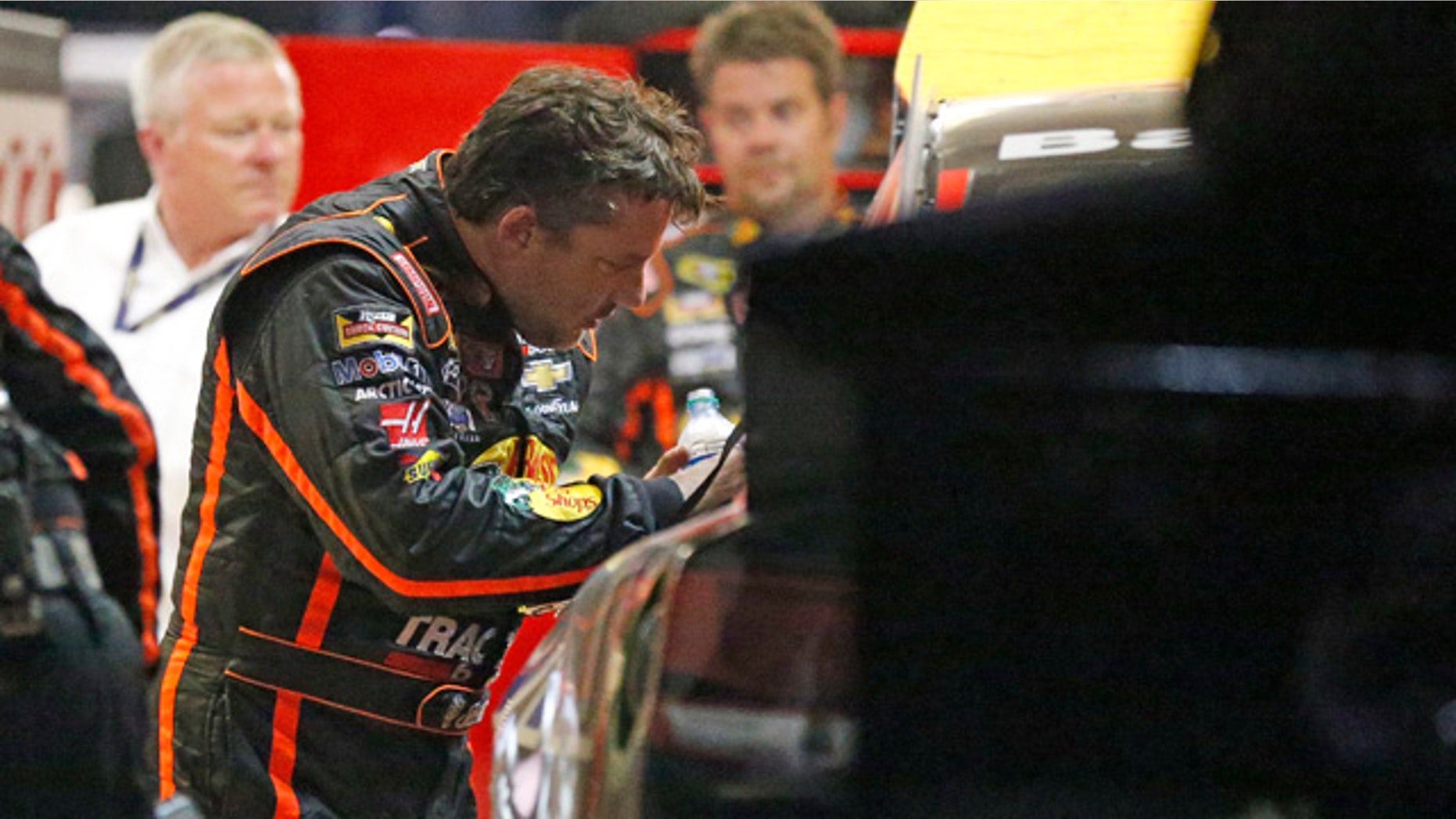August 31, 2014: Sprint Cup Series driver Tony Stewart (14) looks over the damage to his car after he hit the wall during a NASCAR Sprint Cup auto race at Atlanta Motor Speedway in Hampton, Ga.. (AP Photo/Brynn Anderson)